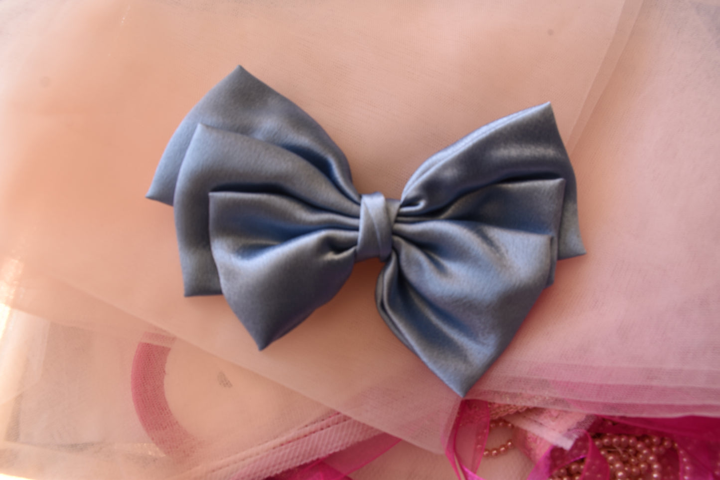 Ocean Drop Hair Bow Clip - Front view of a large metallic ice blue satin hair bow, combining sophistication, charm, and timeless elegance.