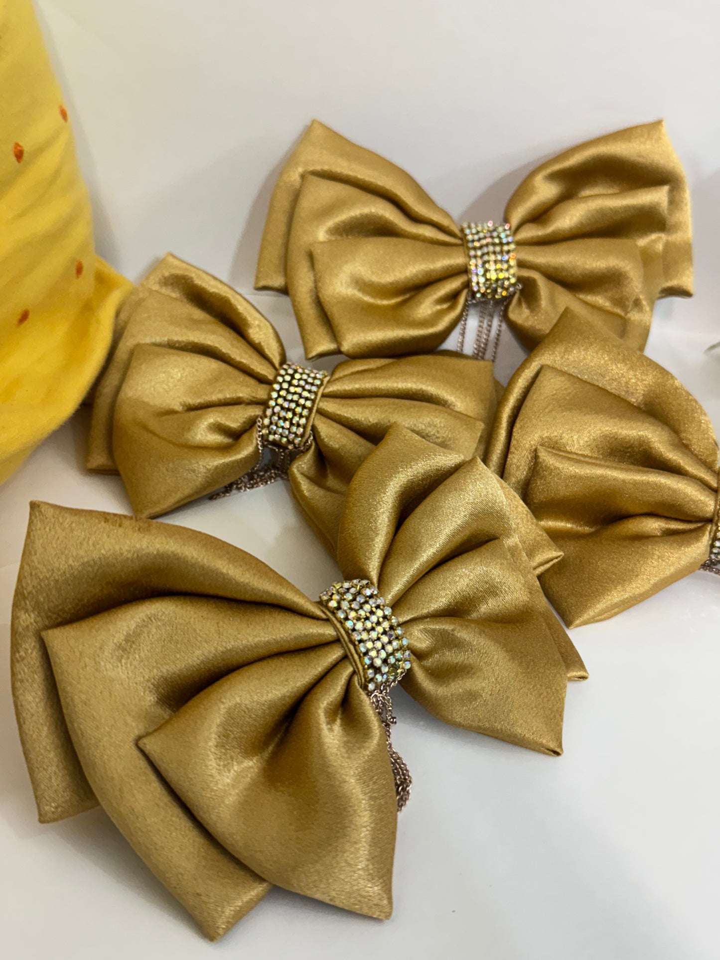 Collection of Goldy Bling Satin Hair Bows ā stunning gold satin hair accessories with intricate stone and chain detailing, neatly arranged front-facing