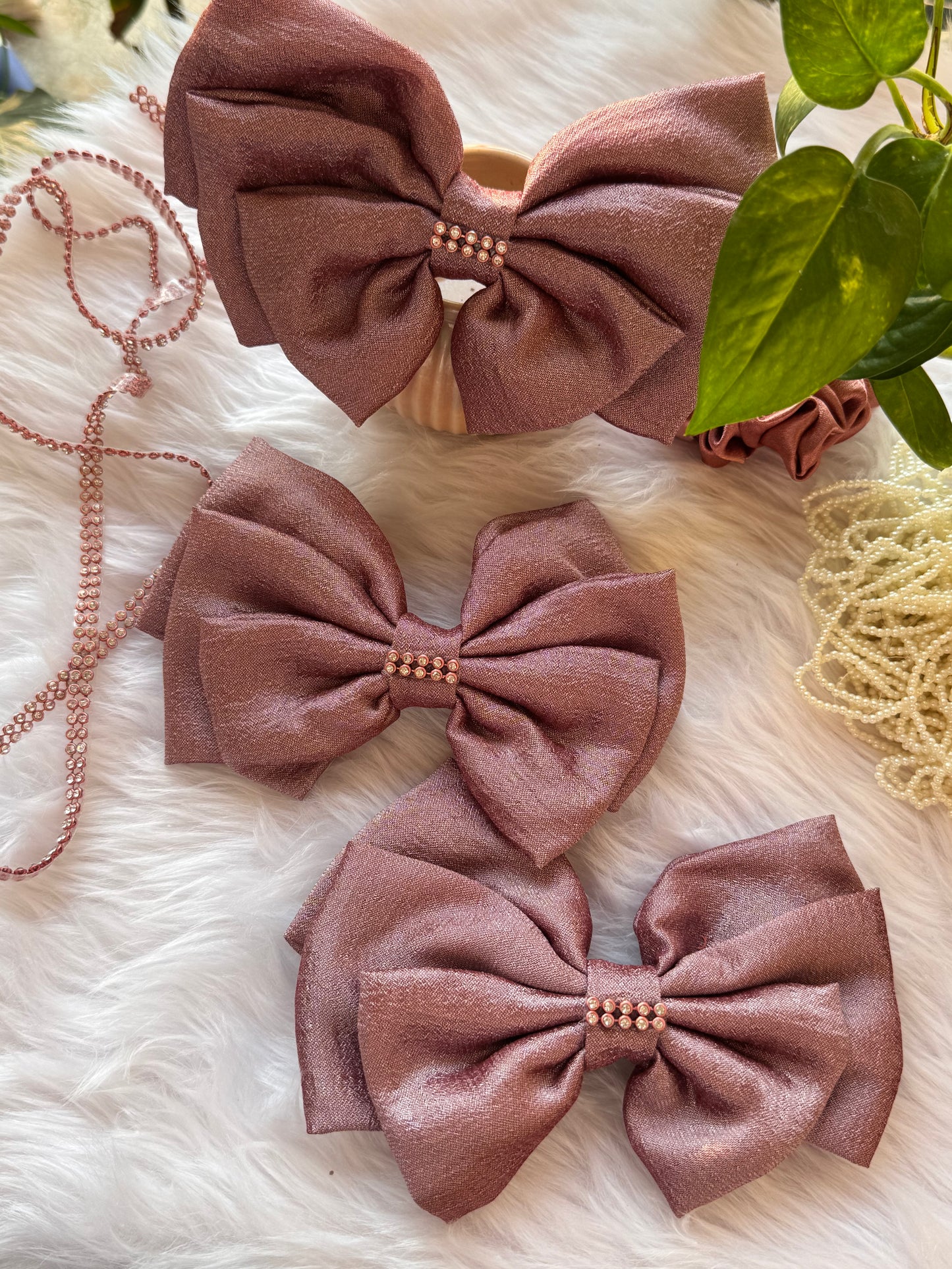 Collection of Rose Gold Satin Hair Bows ā stylish Vichitra silk hair accessories with stone detailing, neatly arranged front-facing