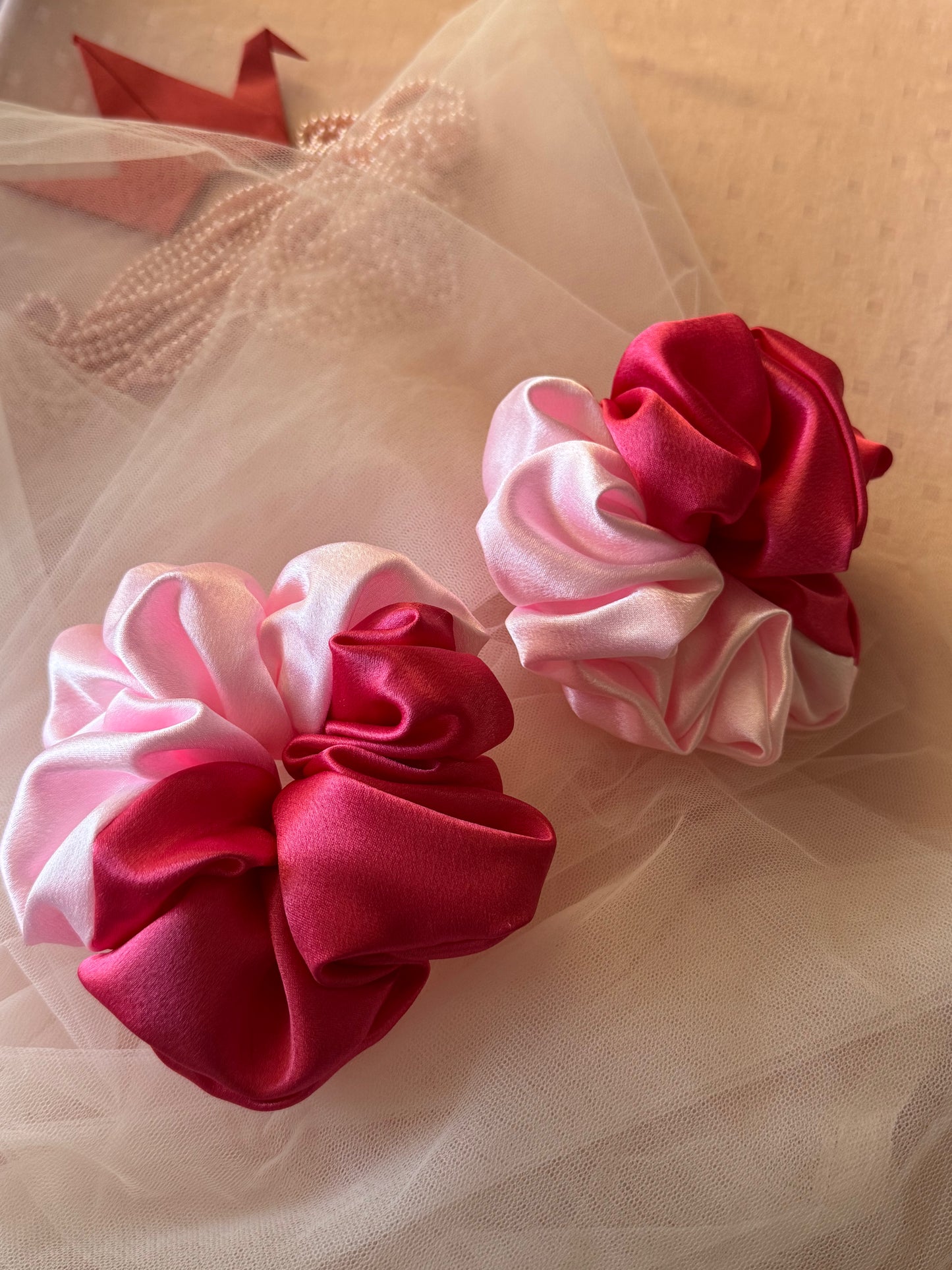 Two Scrunchies outlining the beautiful light and dark pink shades displayed with both colors Vertically kept aligned non parallely