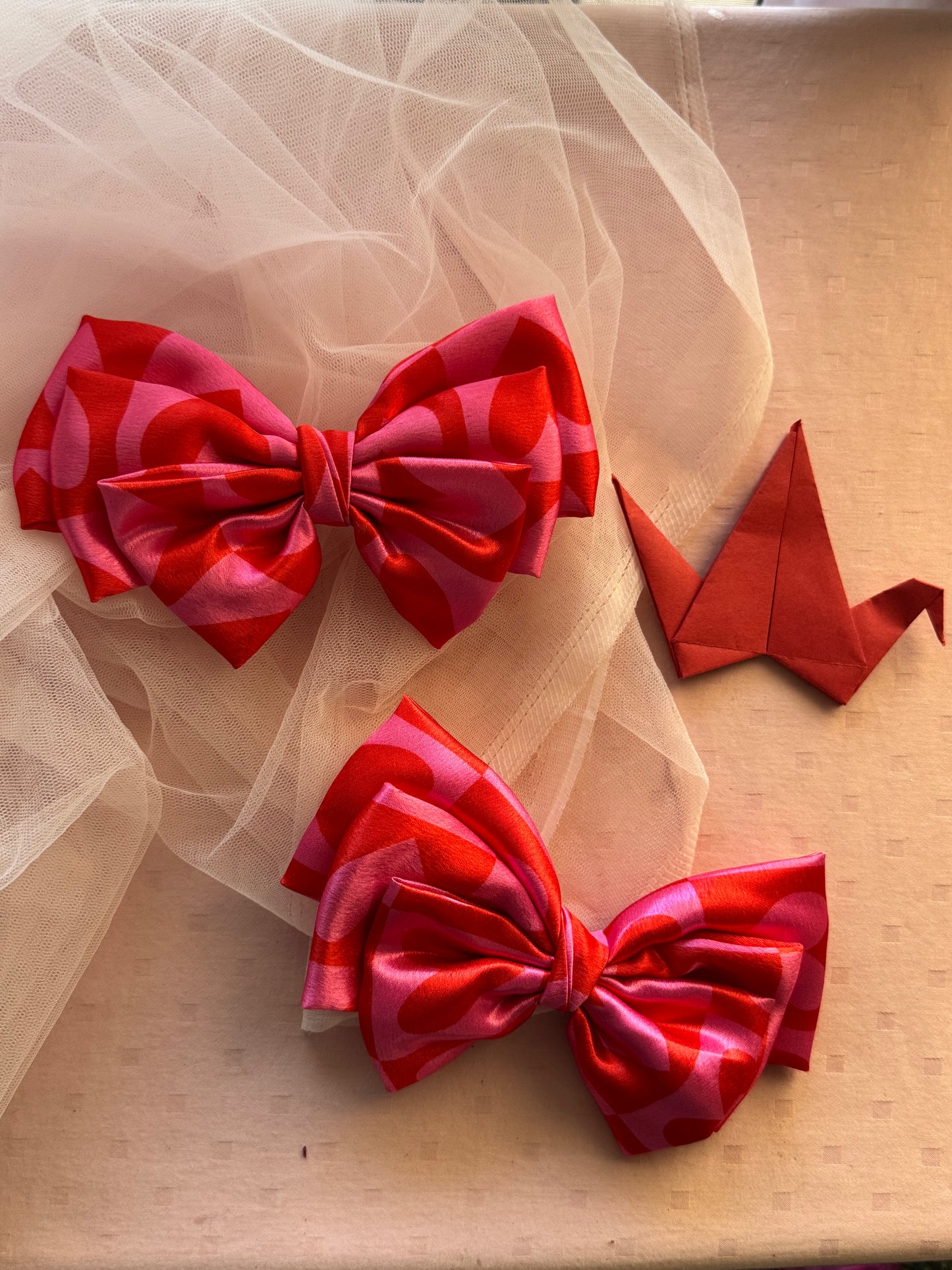 Two Love Struck Hair Bows - Front view of large pink satin hair bow clips with heart prints, perfect for adding a bold yet playful touch to any hairstyle