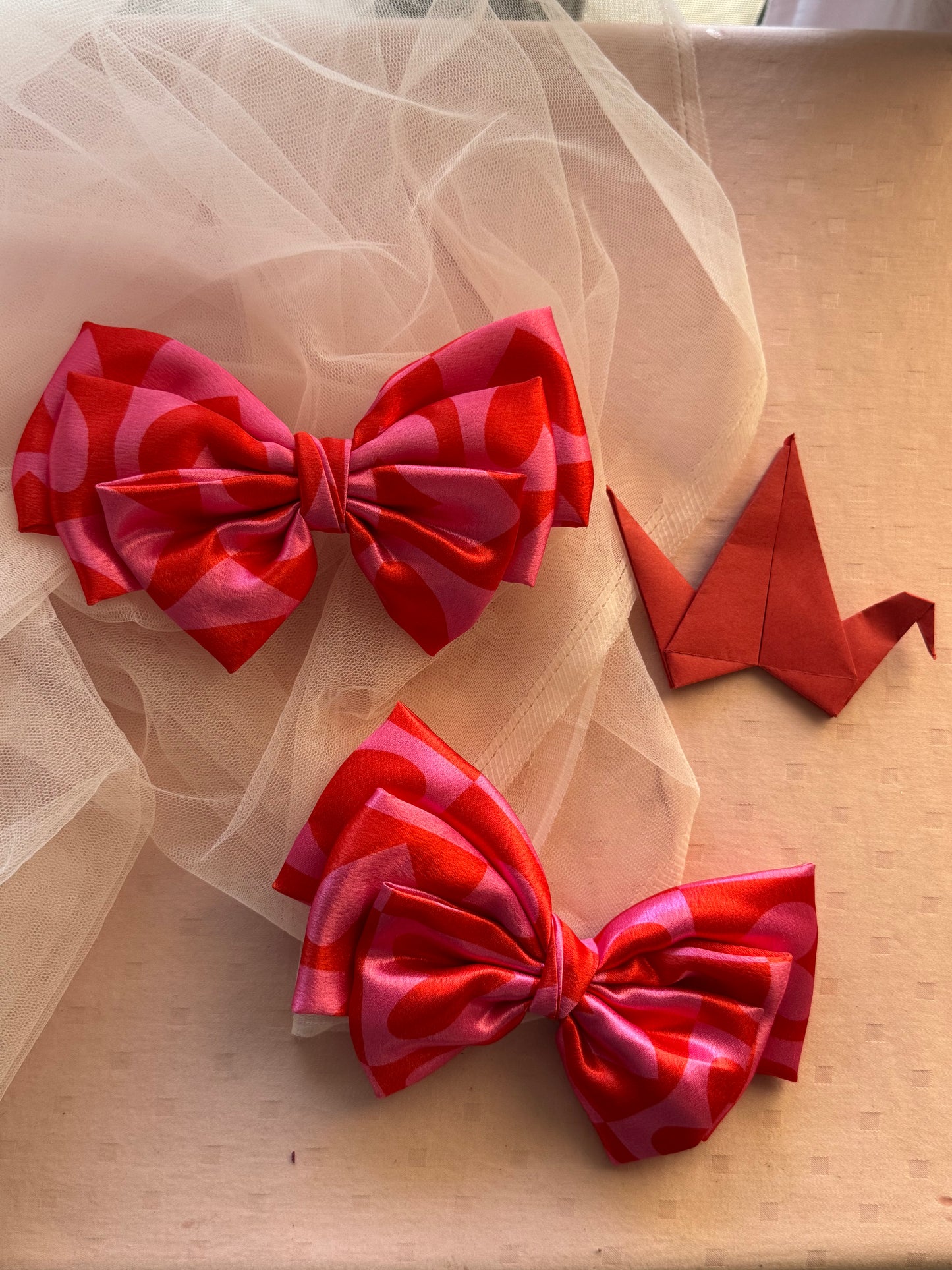 Two Love Struck Hair Bows - Front view of large pink satin hair bow clips with heart prints, perfect for adding a bold yet playful touch to any hairstyle