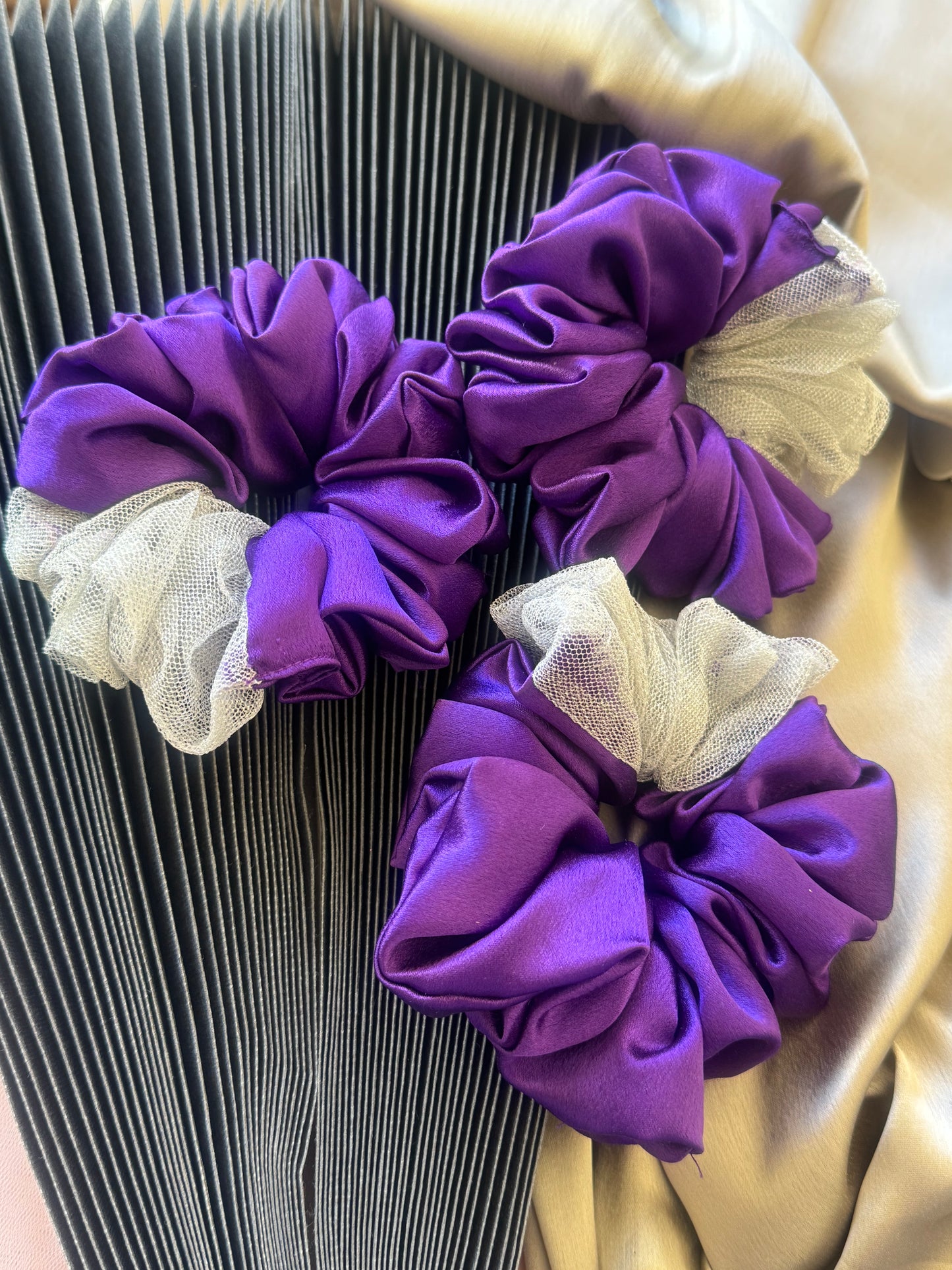 Multiple Purple Silver Snow Scrunchies - Front view of a collection of deep purple and shimmering silver satin and net scrunchies, perfect for casual, formal, or everyday styling.