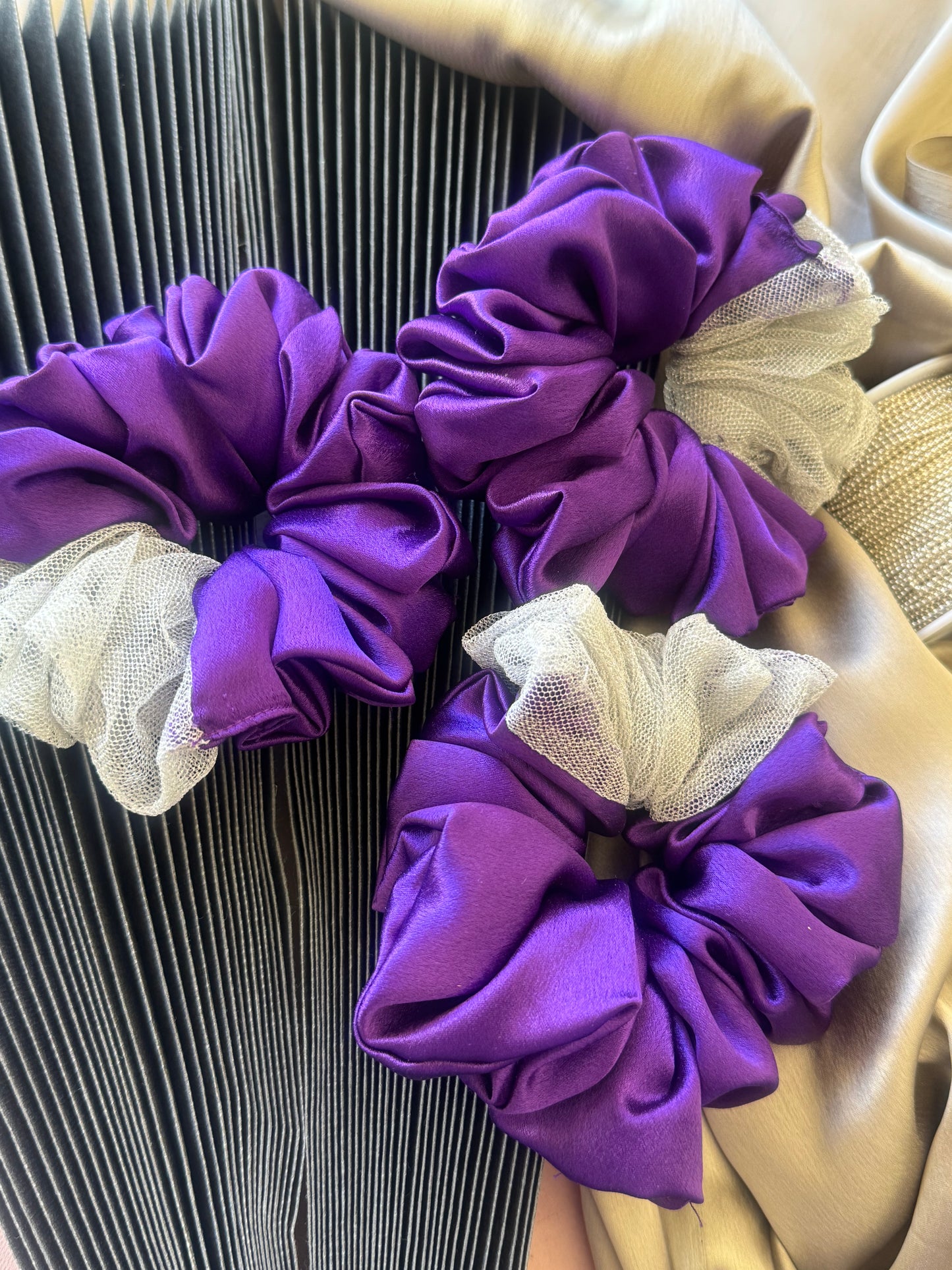 Multiple Purple Silver Snow Scrunchies - Front view of a collection of deep purple and shimmering silver satin and net scrunchies, perfect for casual, formal, or everyday styling.