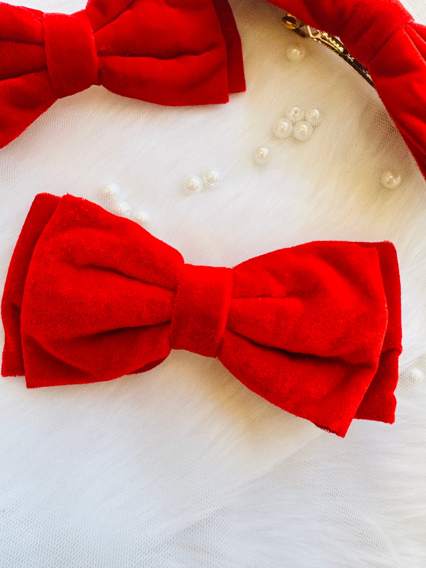 Three Red Velvet Hair Bows - Front view of a set of crimson red premium velvet hair bow clips, ideal for making a bold and sophisticated statement. Shows part back view of one of them.