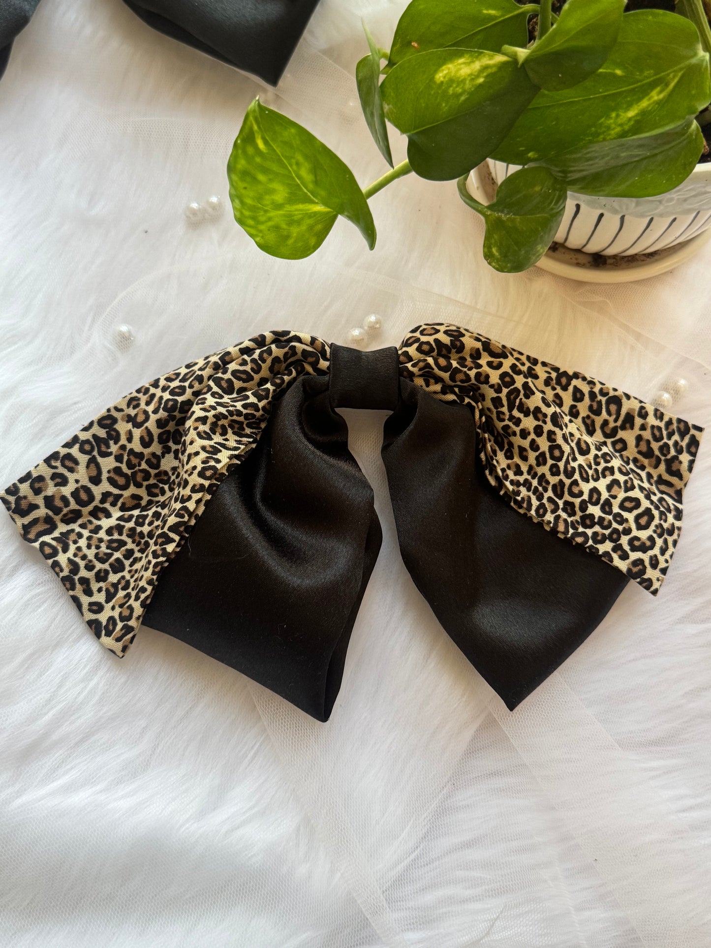 Kate Moss Hair Bow Clip - Oversized black satin and leopard print hair bow for bold, fashion-forward styling, highlighting below fabric.