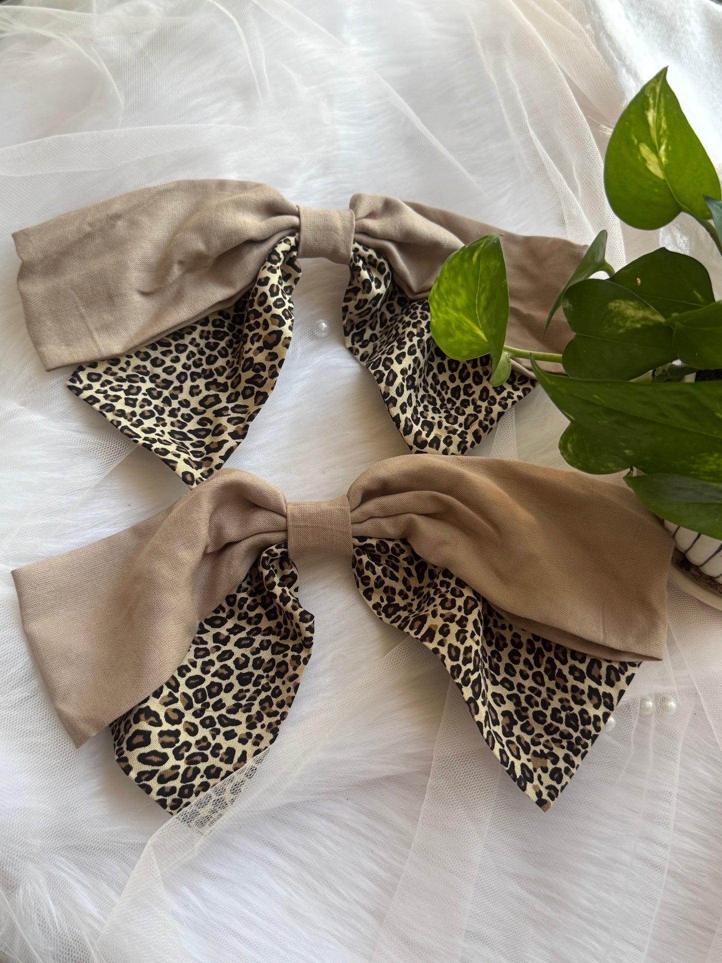 Two Madonna Hair Bows - Front view of oversized beige and leopard print hair bow clips, perfect for fierce and timeless looks.