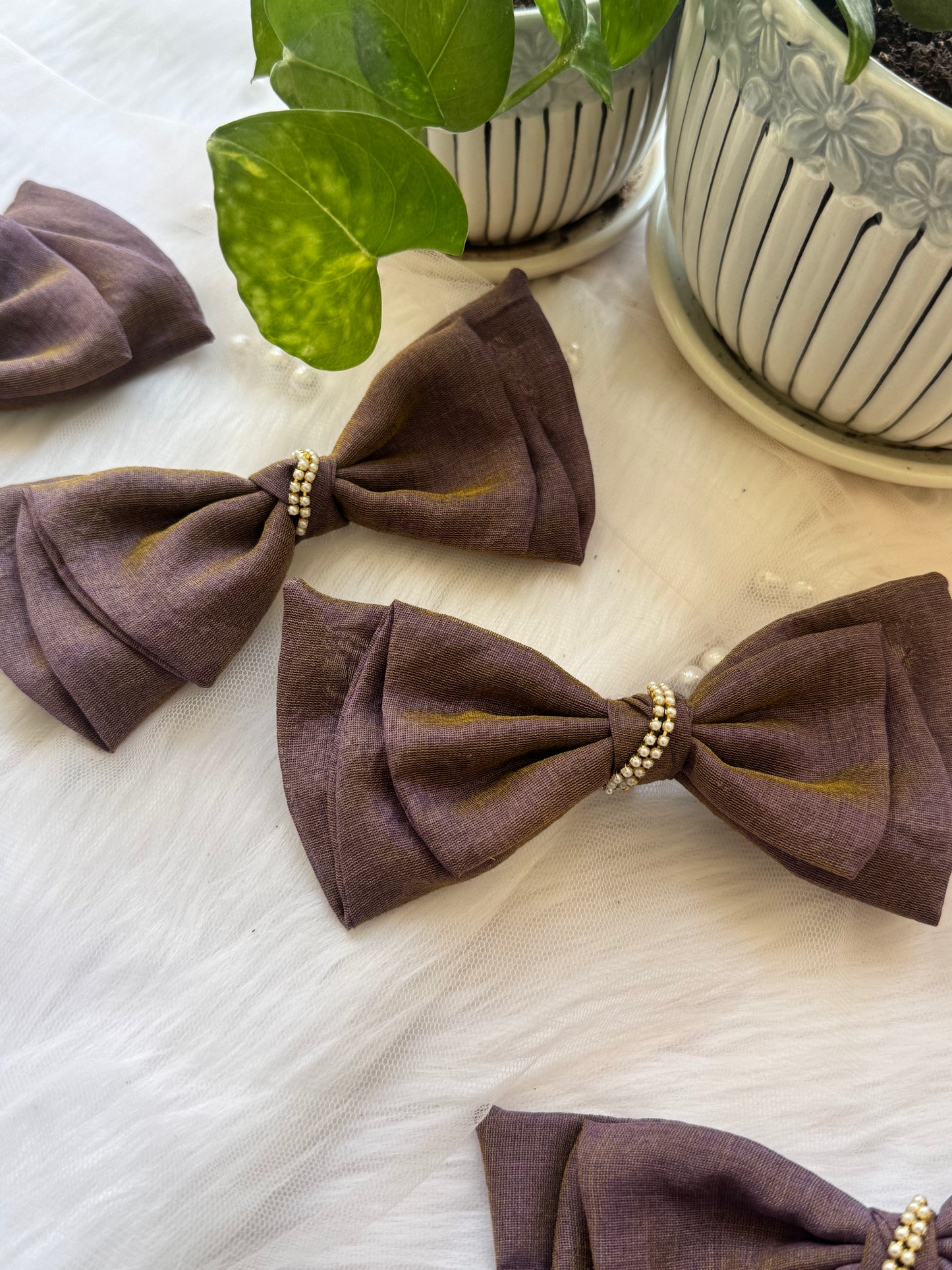 Three Blackcurrant Ice Hair Bows - Front view of a set of light brown cotton hair bow clips, perfect for versatile and sophisticated looks angled in an obtuse way.