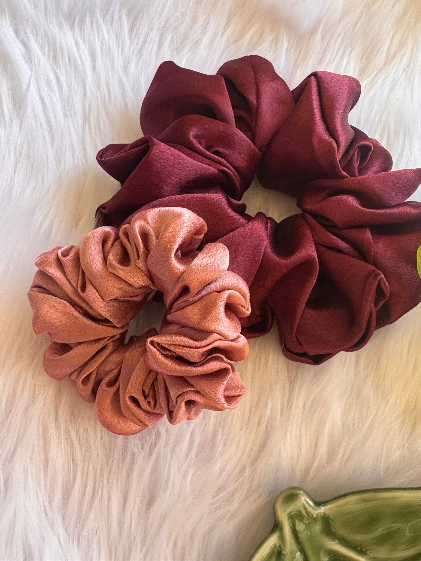 Peachy Fizz satin scrunchies duo in dark fuchsia and peach pink showing fluffy texture on white fur background by Bows and