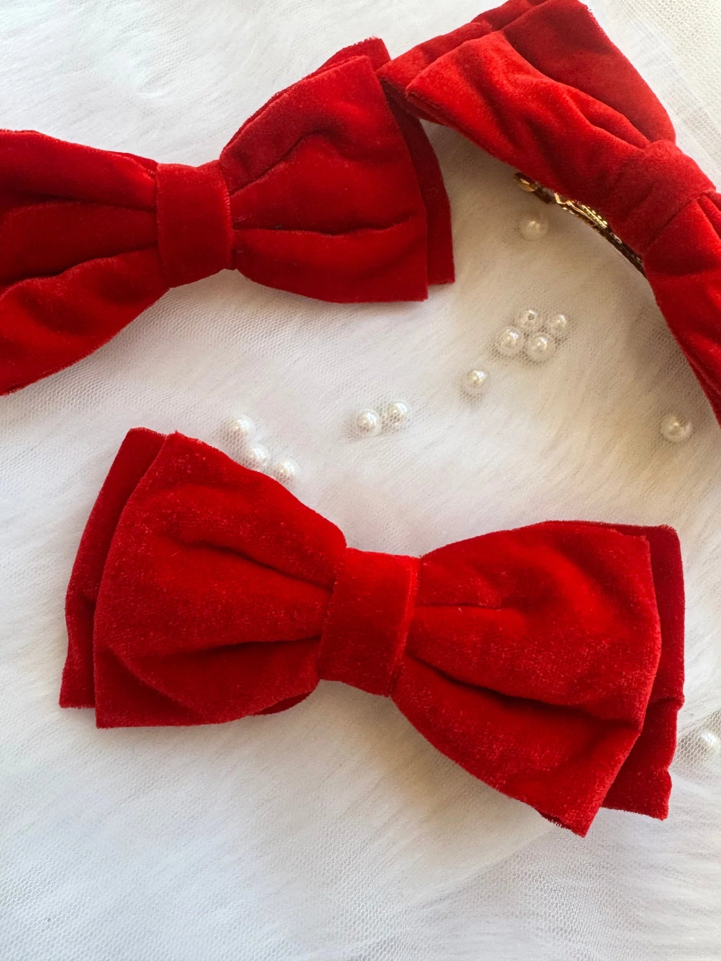 Red velvet handmade hair bows with pearl embellishments by Bows and Bags India, premium textile accessories