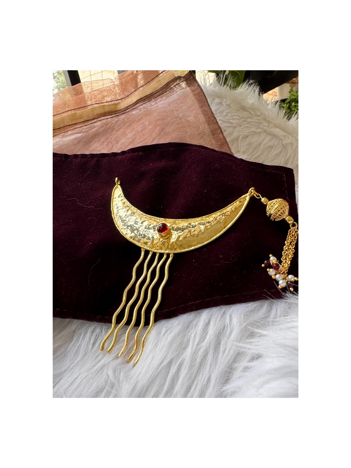 Gold crescent moon-shaped hair accessory with red gemstone 