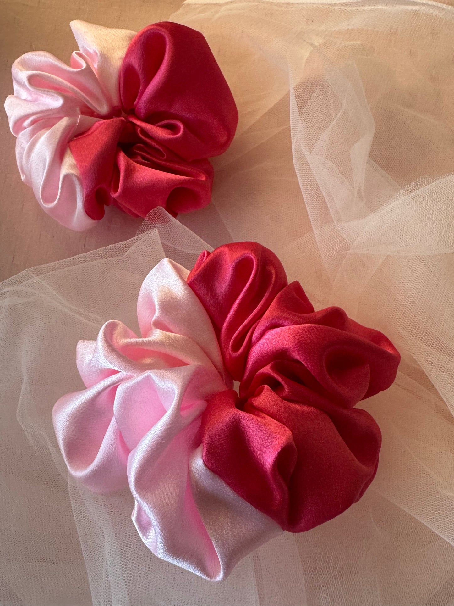 Two Scrunchies outlining the beautiful light and dark pink shades displayed with both colors in white background
