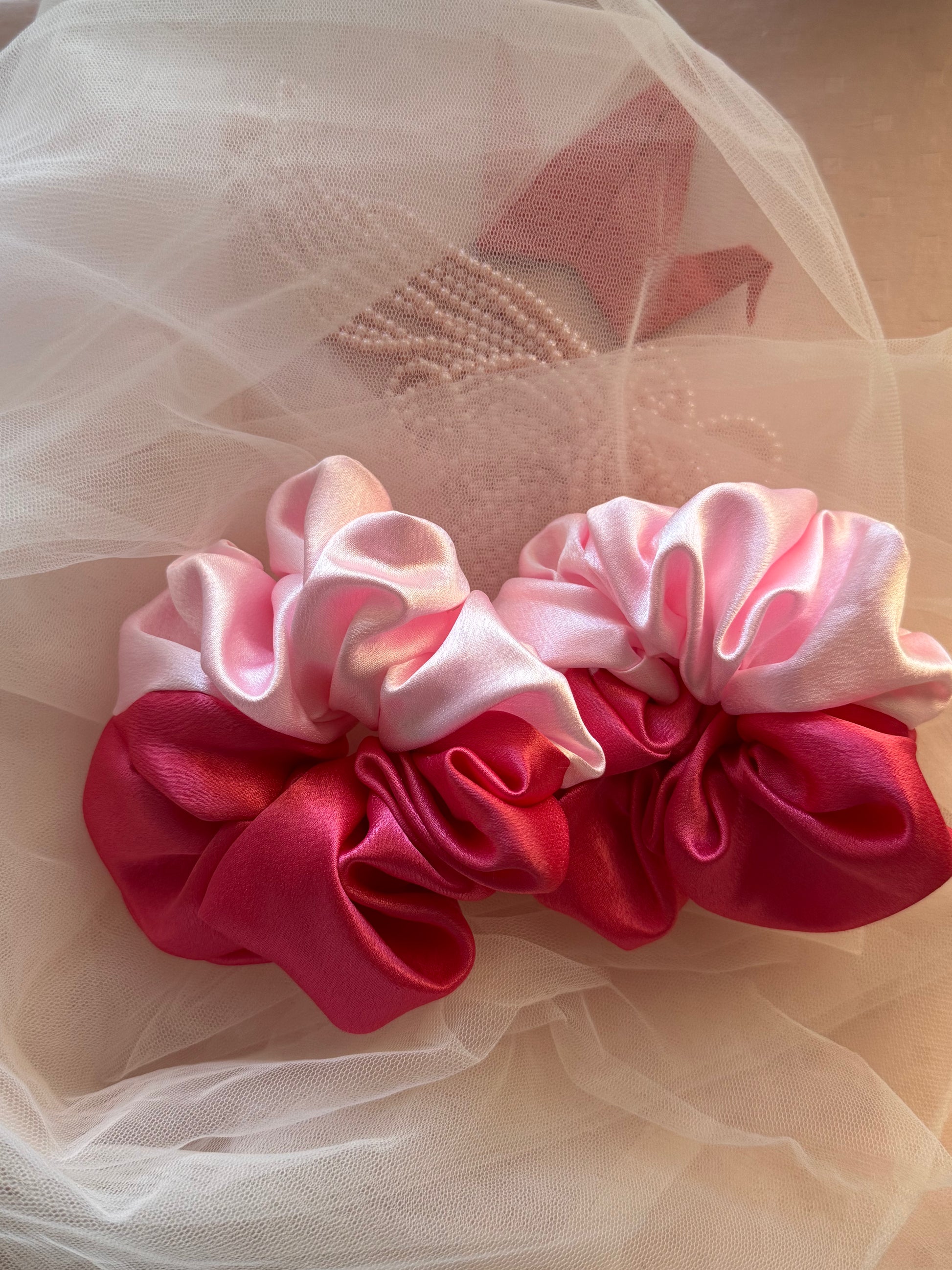 Two Scrunchies outlining the beautiful light and dark pink shades displayed with both colors Horizontally kept aligned parallely