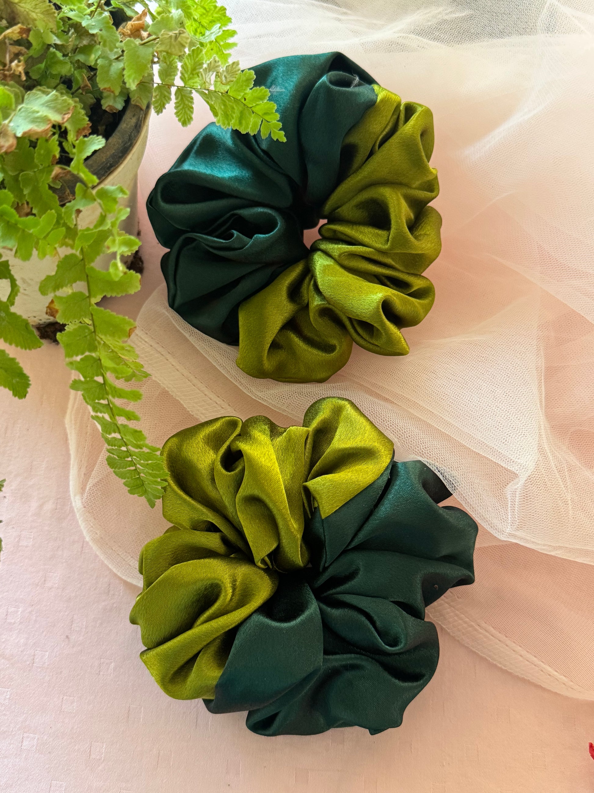 Two elegant XL satin scrunchies in olive and dark green, designed for thick or thin hair, offering a smooth, damage-free hold for stylish everyday or formal hair accessories.