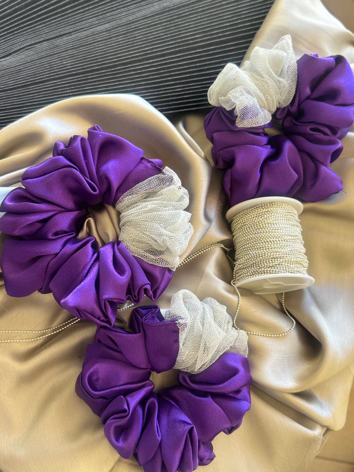 Multiple Purple Silver Snow Scrunchies - Front view of a collection of deep purple and shimmering silver satin and net scrunchies, perfect for casual, formal, or everyday styling.