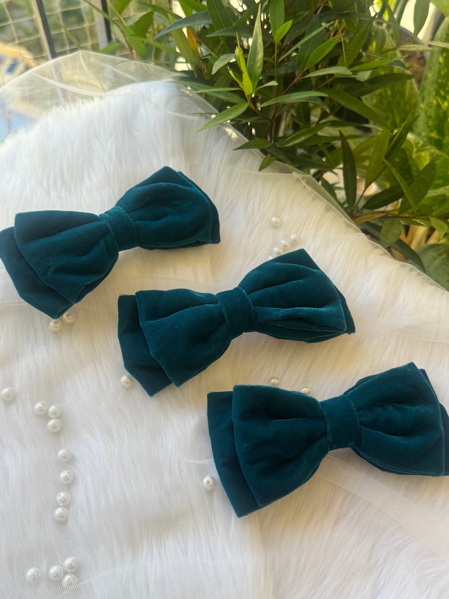 Three Blueberry Pie Hair Bows - Front view of a set of peacock blue premium velvet hair bow clips, ideal for adding bold elegance to any look. Items are kept linearly.