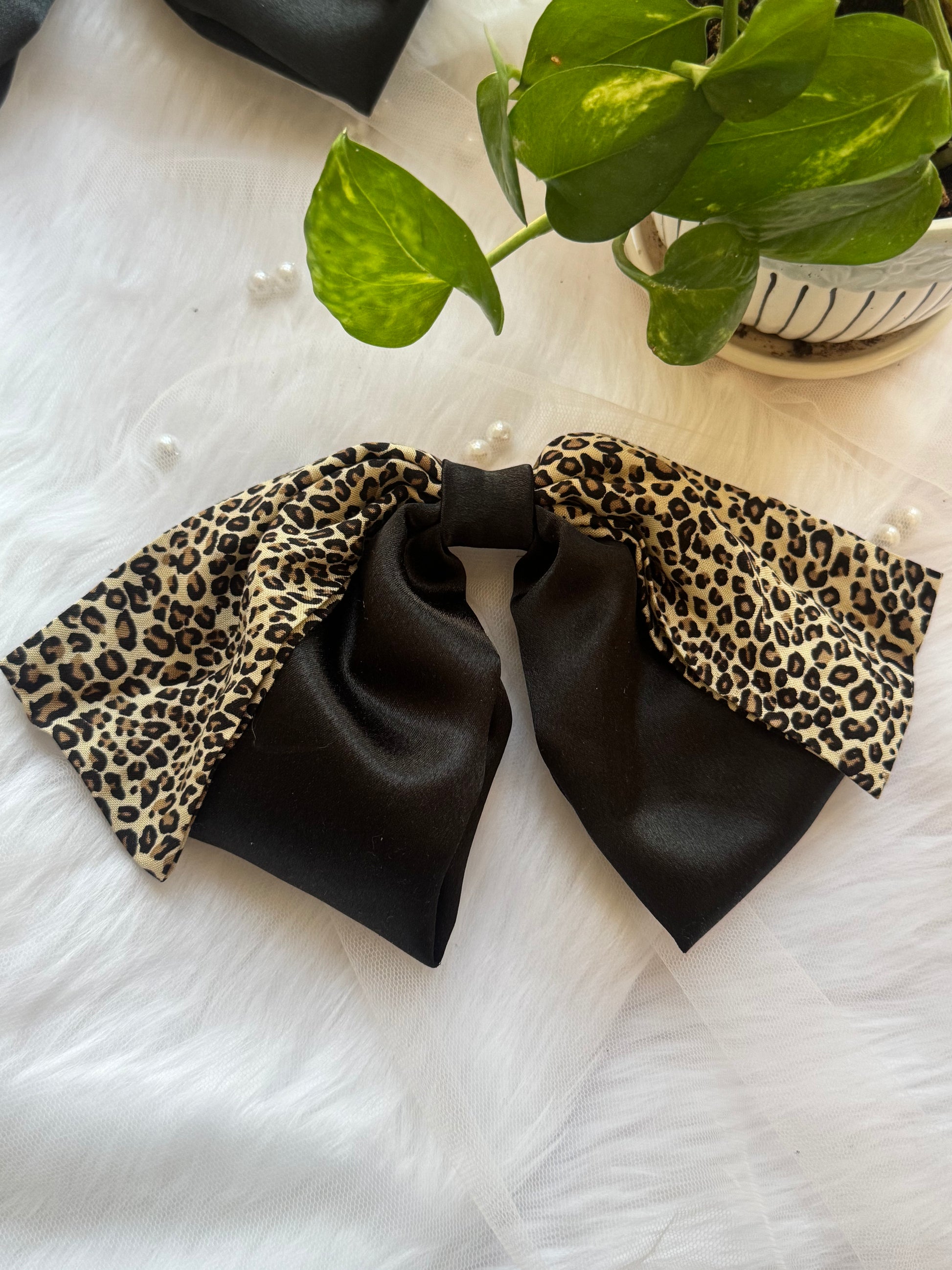 Kate Moss Hair Bow Clip - Oversized black satin and leopard print hair bow for bold, fashion-forward styling, highlighting below fabric.