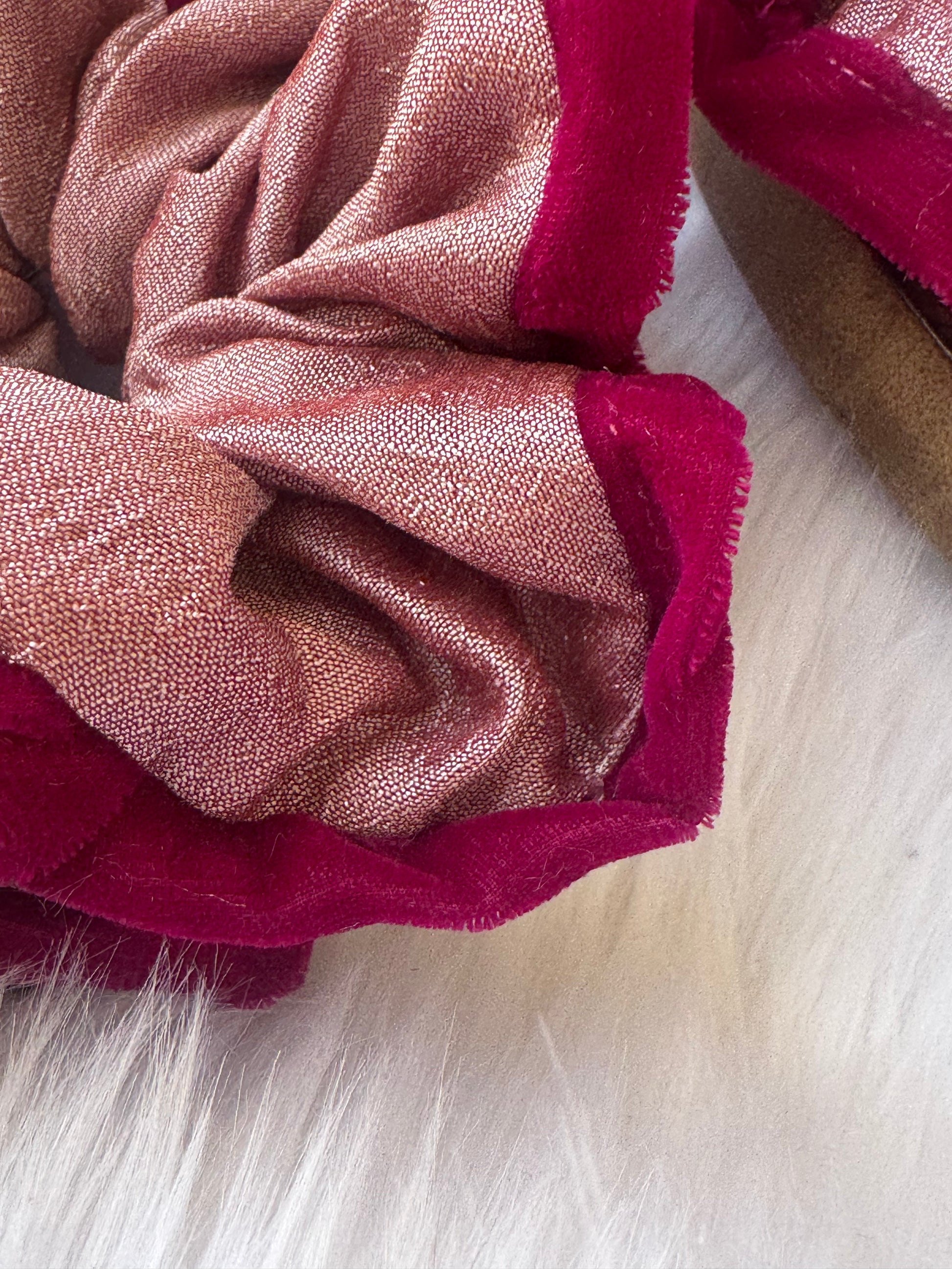 Close-up image of the Damask Roses Scrunchie, showcasing its smooth silk fabric, plush deep pink velvet border, and secure elastic band