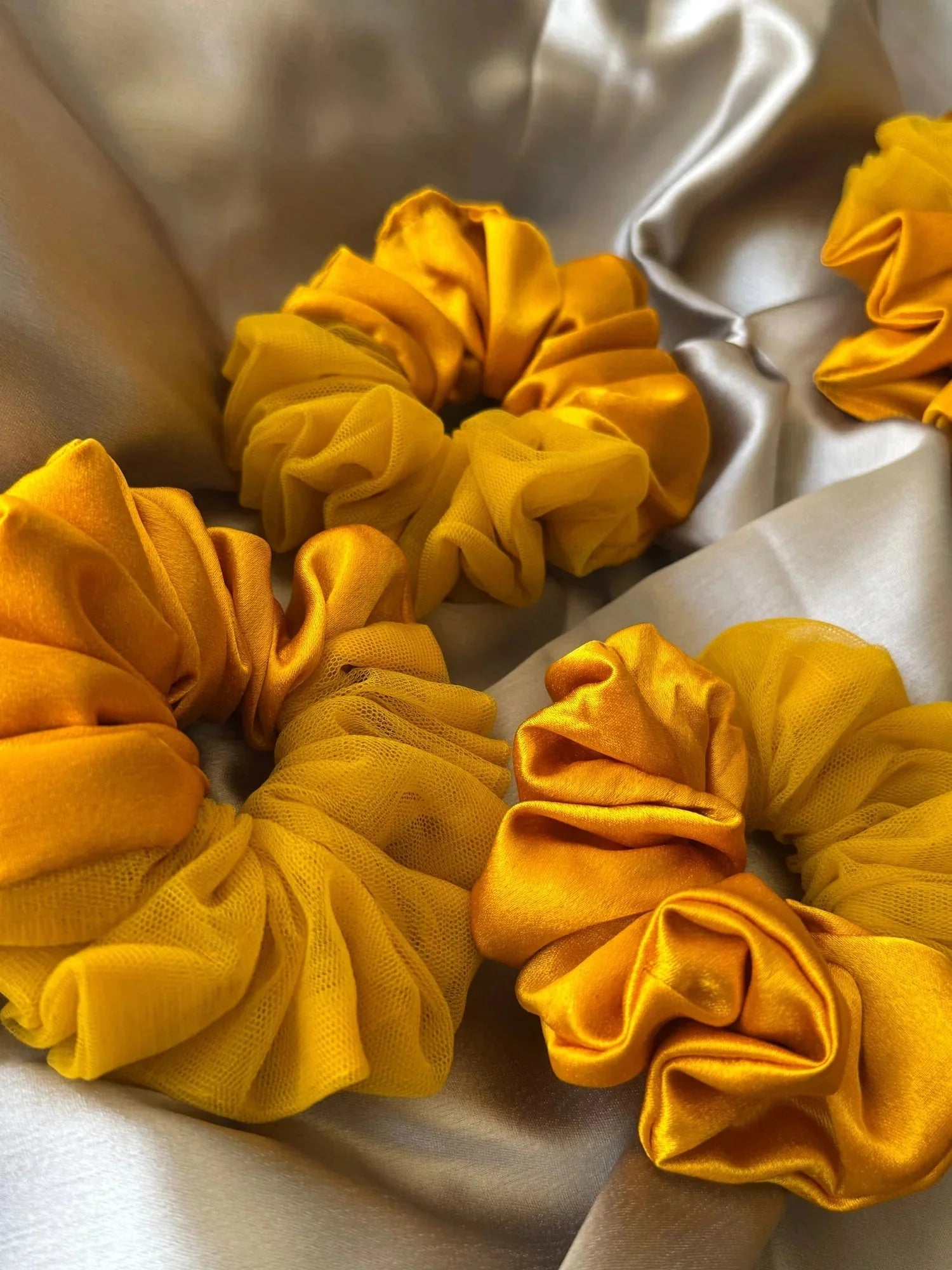 Handmade mustard yellow satin scrunchies with net detailing by Bows and Bags India, close-up texture view showing fabric