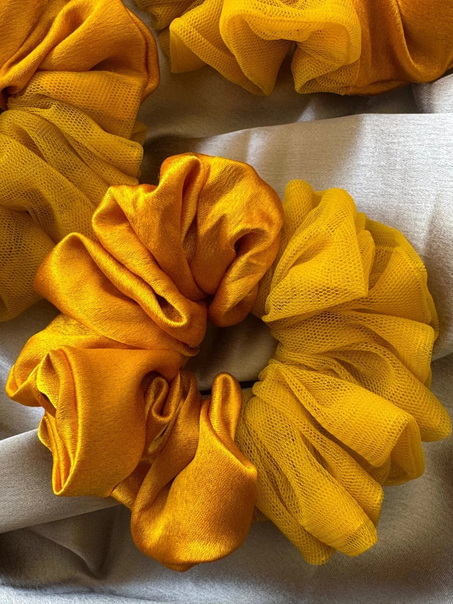 Mustard yellow satin net scrunchie with voluminous ruffled texture by Bows and Bags India, handmade hair accessory detail