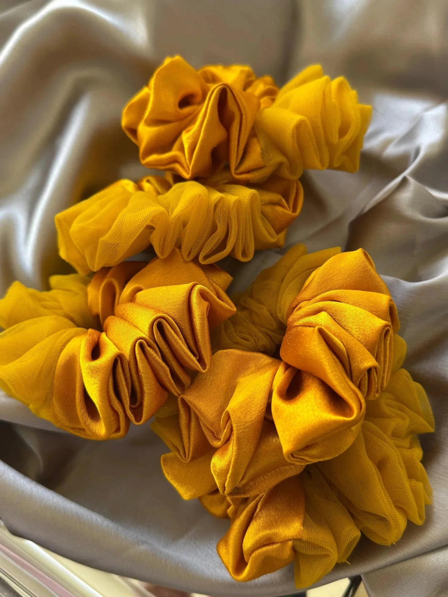 Amber Sun mustard yellow satin scrunchies with net detailing by Bows and Bags India, handmade hair accessories arranged on