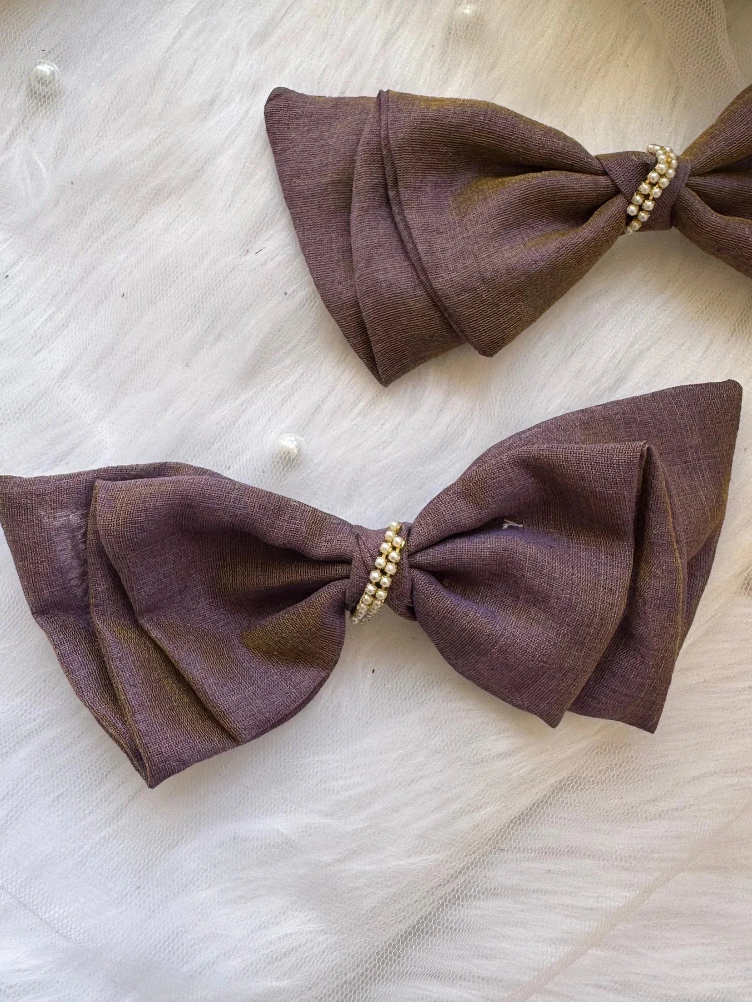 Two handmade cotton hair bow clips in blackcurrant violet and brown dual tone with pearl details by Bows and Bags India