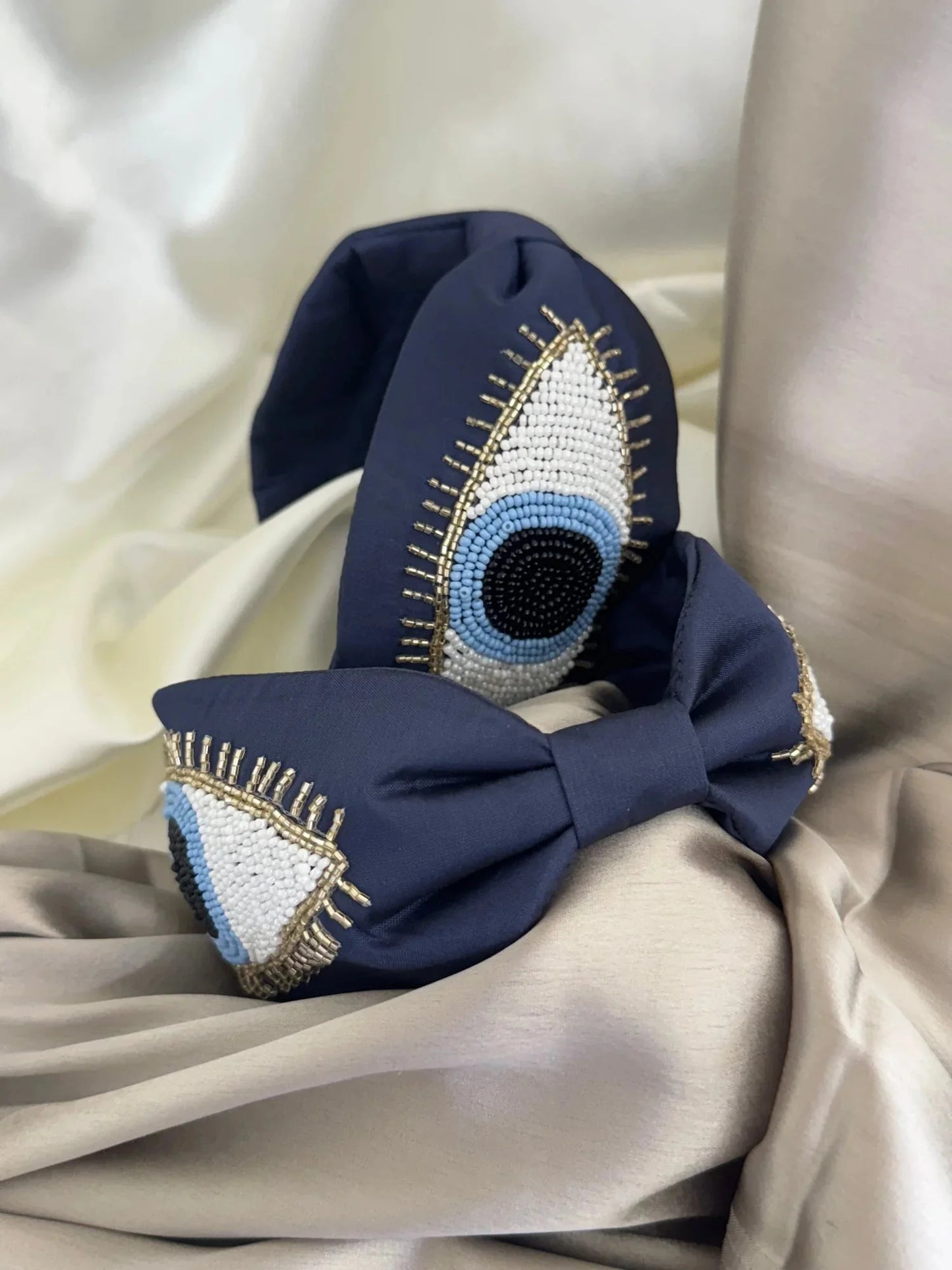 Navy blue satin handmade headband with beaded evil eye design by Bows and Bags India, detailed close-up view