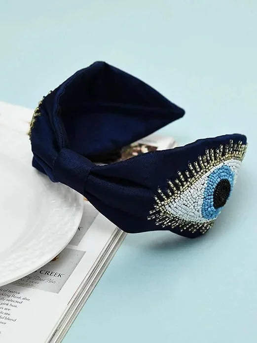 Navy blue satin headband with hand-beaded evil eye design detail by Bows and Bags India, handmade hair accessory close-up