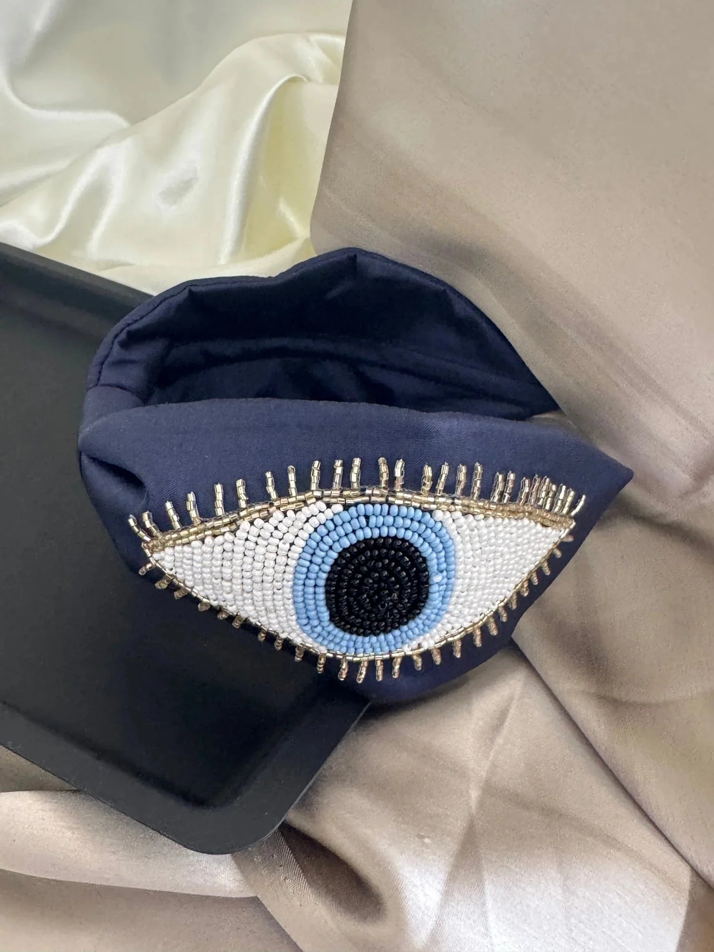 Navy blue satin handmade beaded headband with evil eye design detail by Bows and Bags India