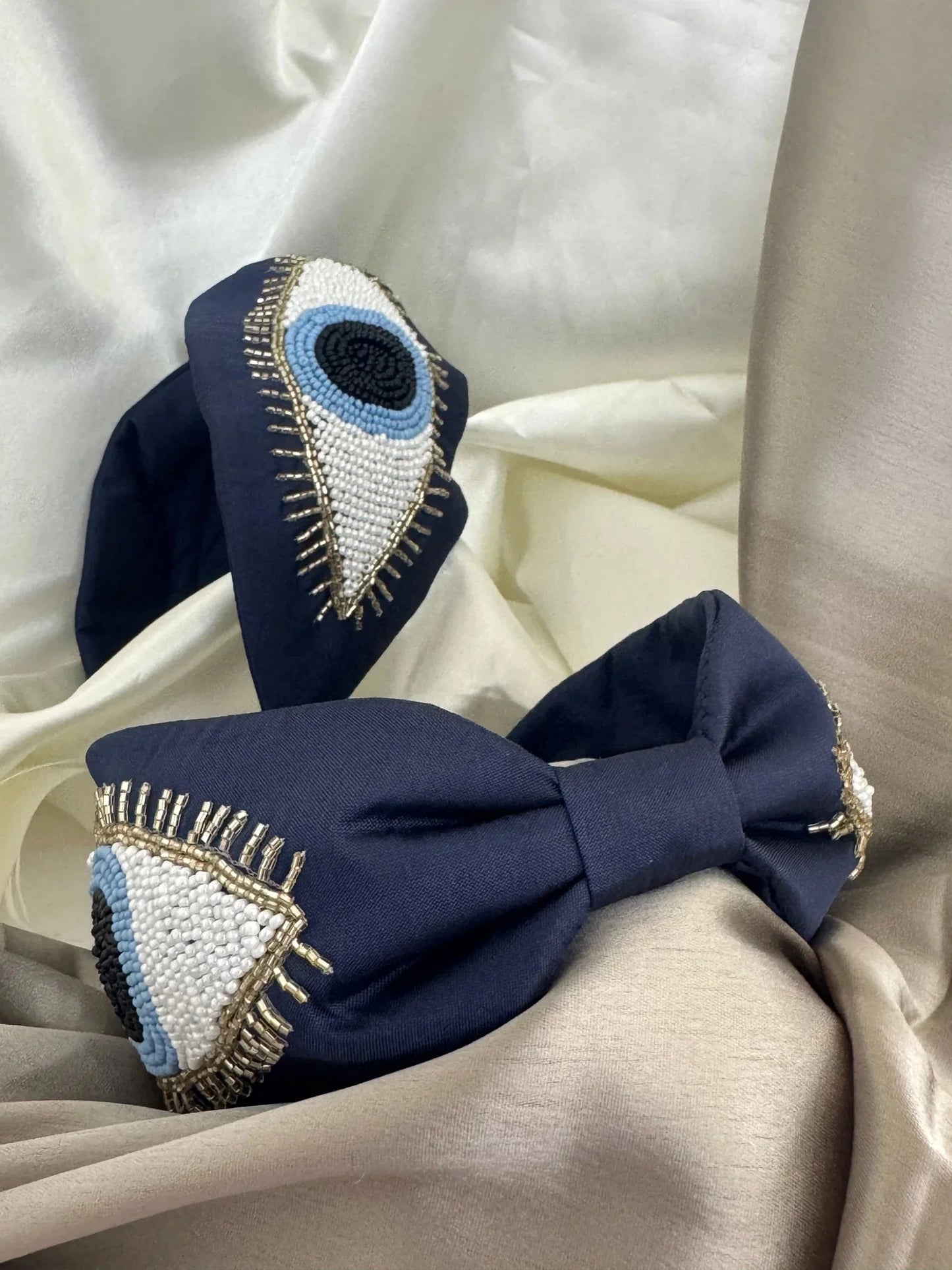 Navy blue satin headband with hand-beaded evil eye design by Bows and Bags India, handmade beaded hair accessory with