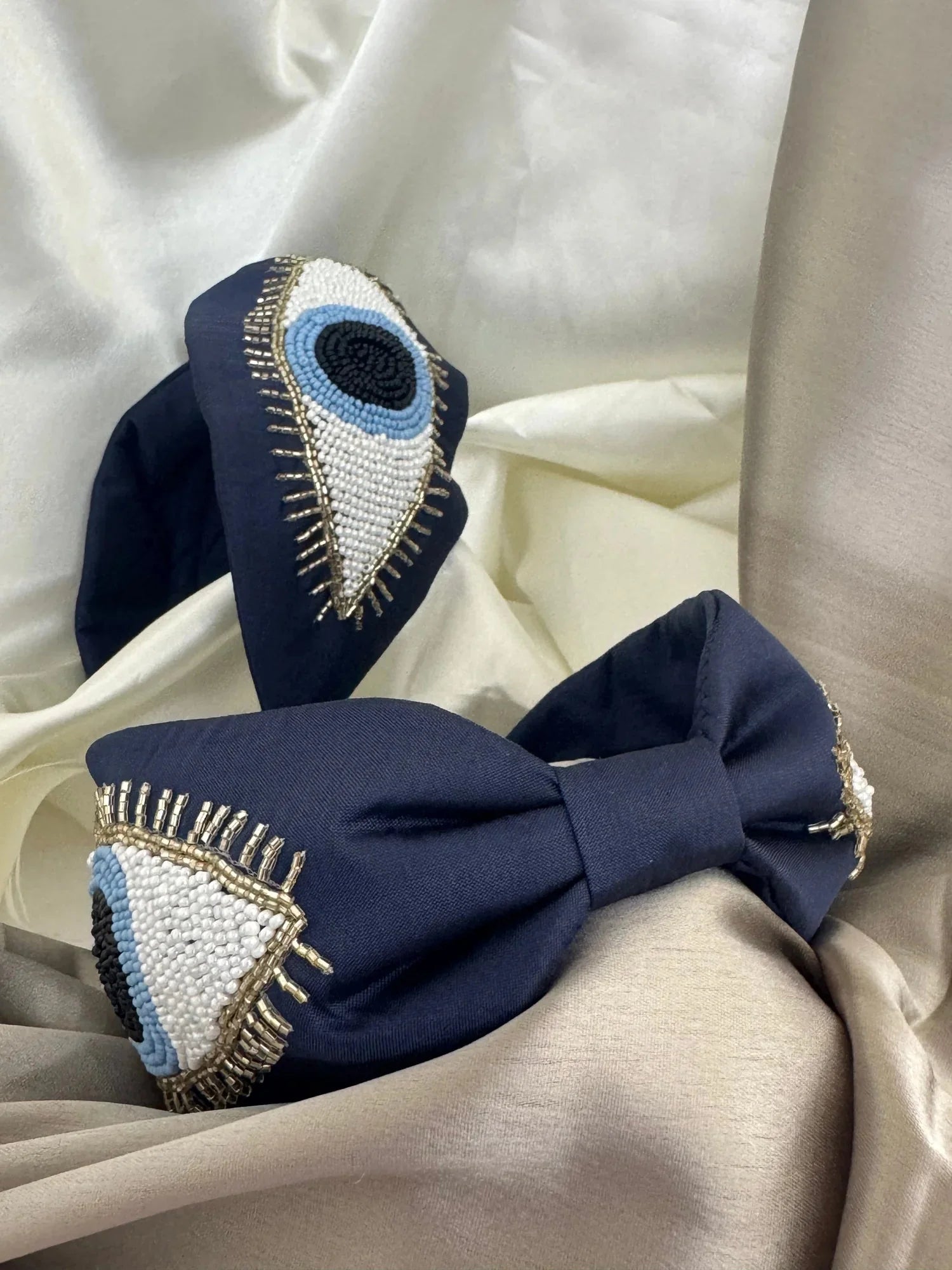 Navy blue satin headband with hand-beaded evil eye design by Bows and Bags India, handmade beaded hair accessory with