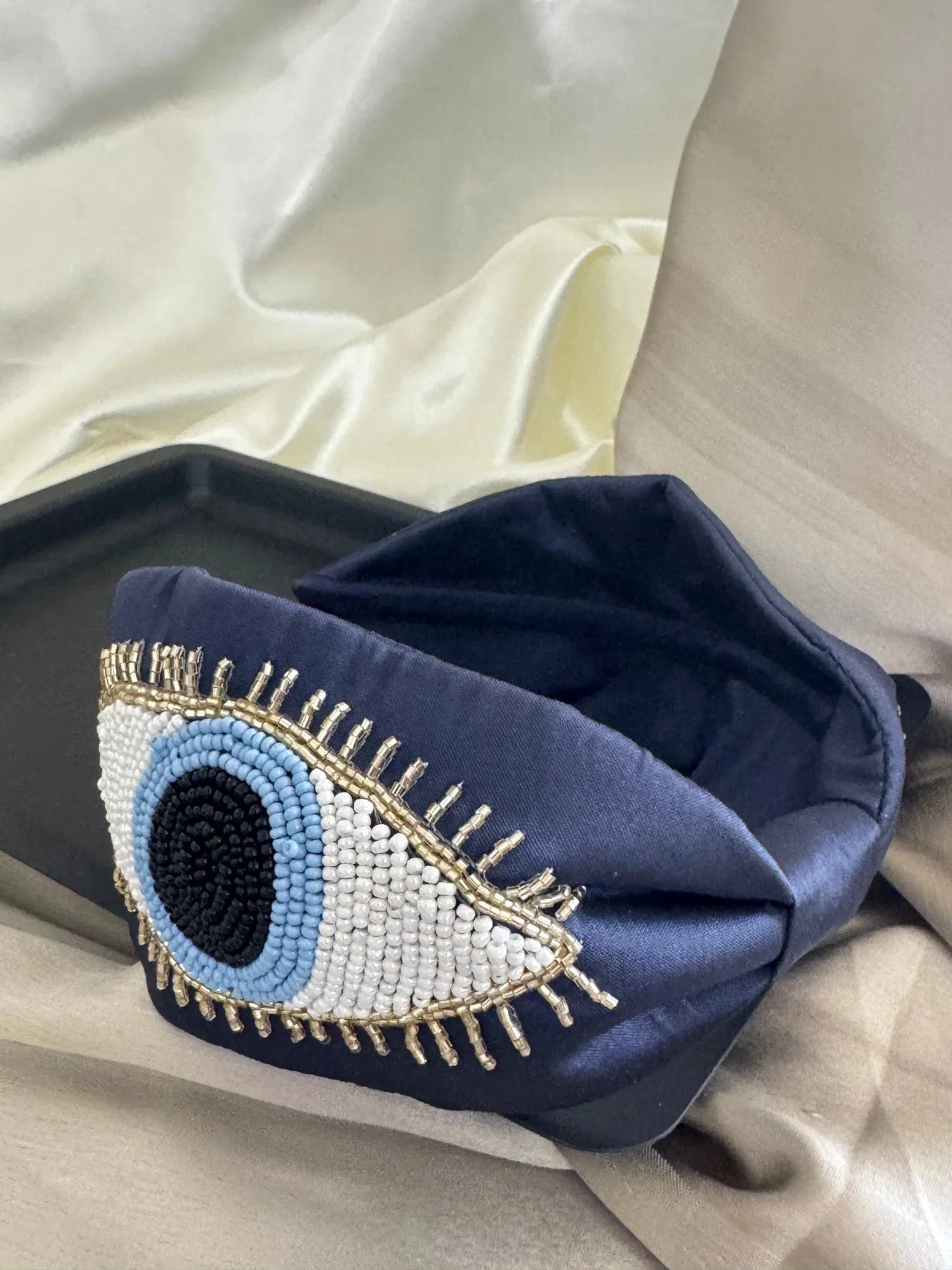 Navy blue satin handmade headband with beaded evil eye design by Bows and Bags India, detail shot showing intricate beadwork