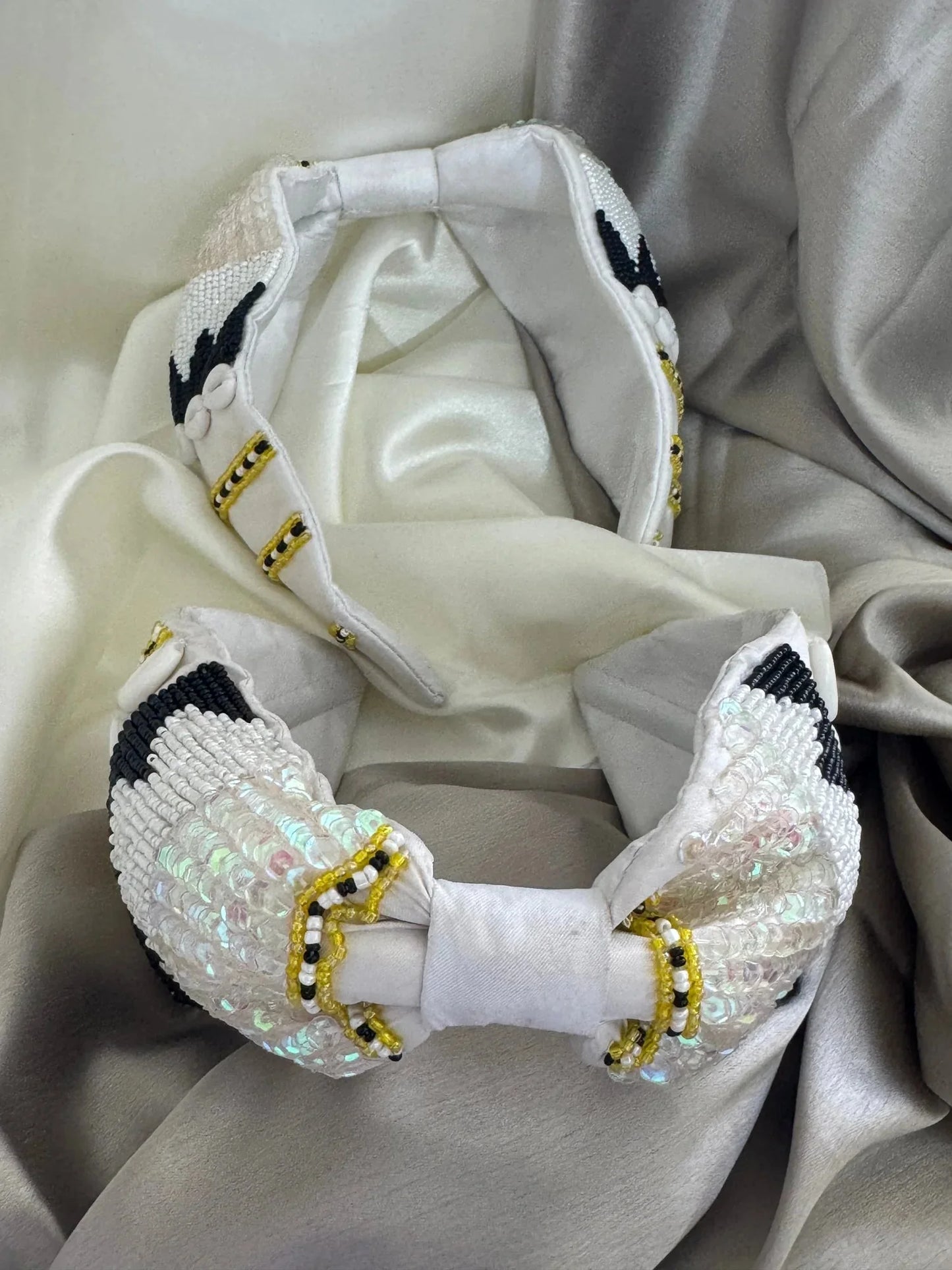 Handcrafted white satin headband with beaded detailing by Bows and Bags India, close-up view of luxurious hair accessory