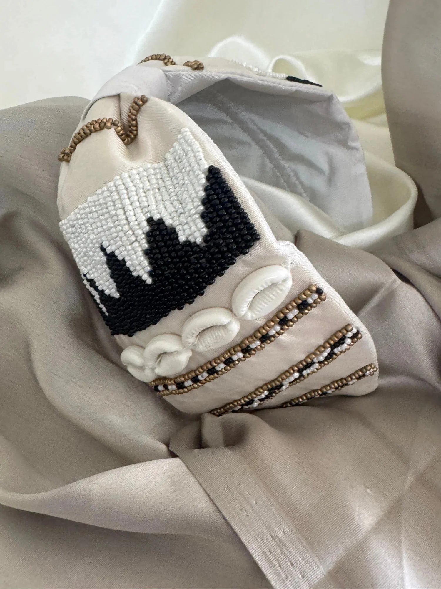 White satin handmade beaded headband with shell detailing by Bows and Bags India, boho hair accessory on neutral fabric