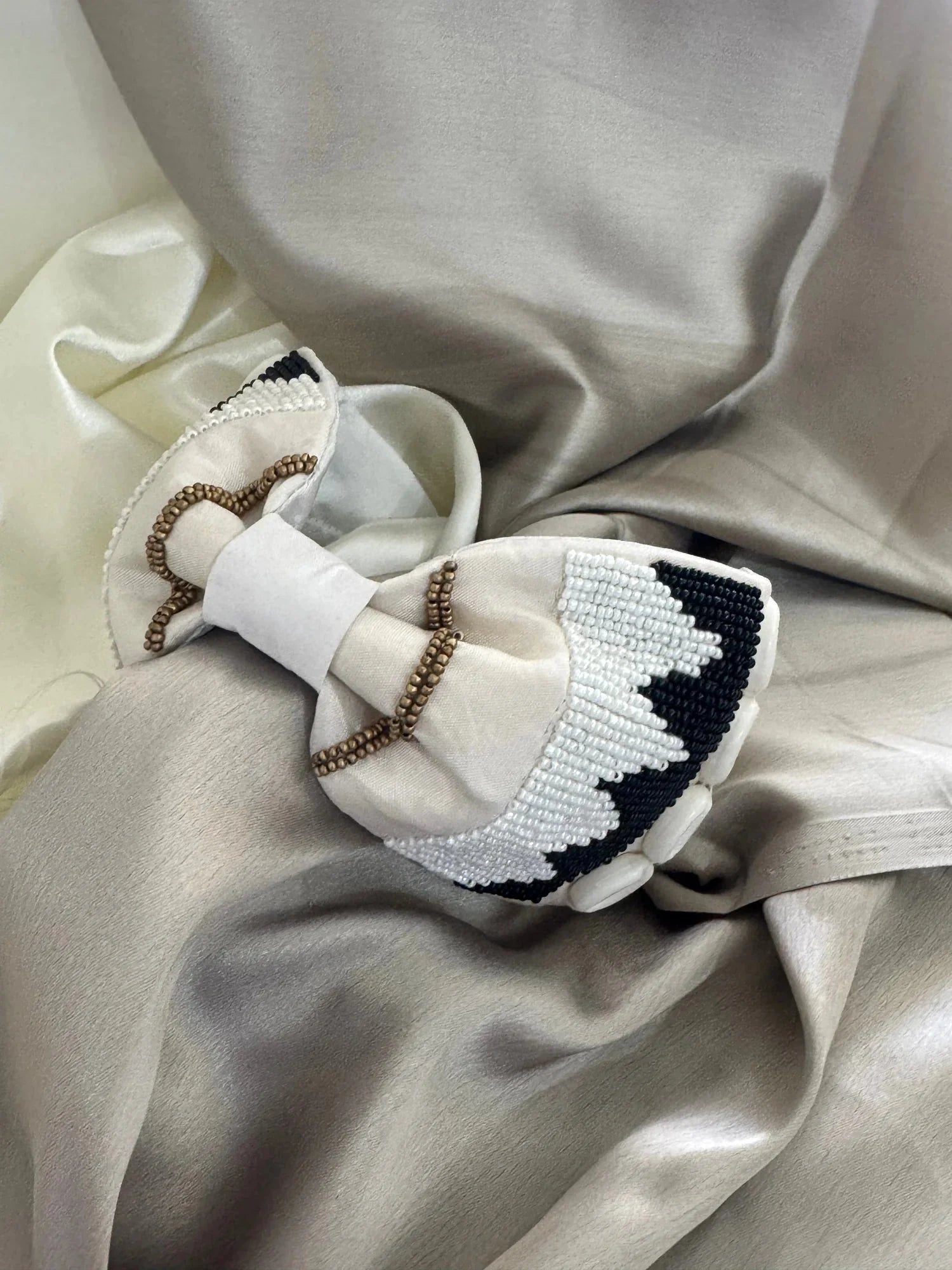 White satin beaded headband with shell detailing by Bows and Bags India, handmade boho hair accessory on neutral fabric