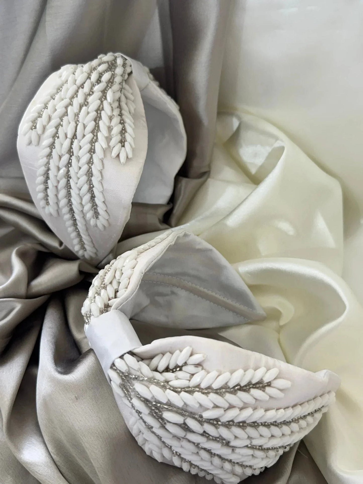 Close-up detail of handmade beaded satin headband by Bows and Bags India showing intricate leaf design embellishments on