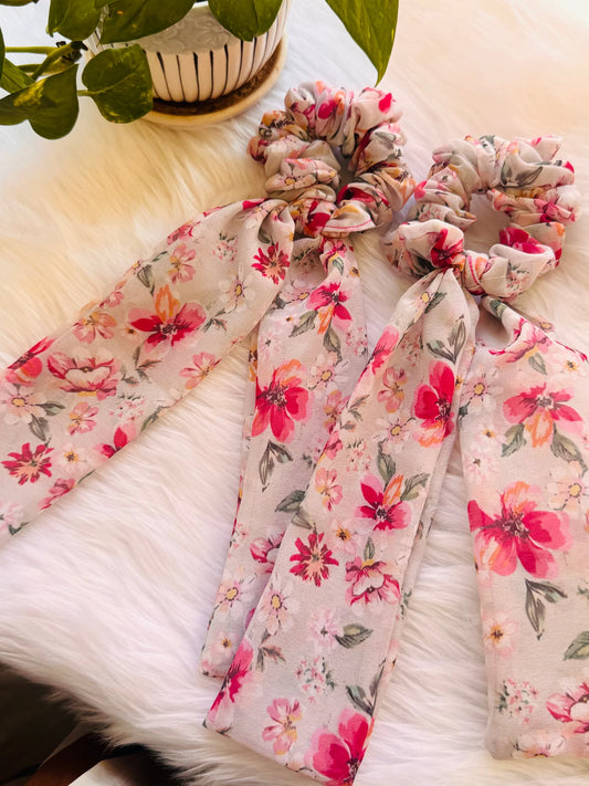 Floral pink georgette tail scrunchies with delicate tails arranged on white fur, handmade hair accessories by Bows and Bags