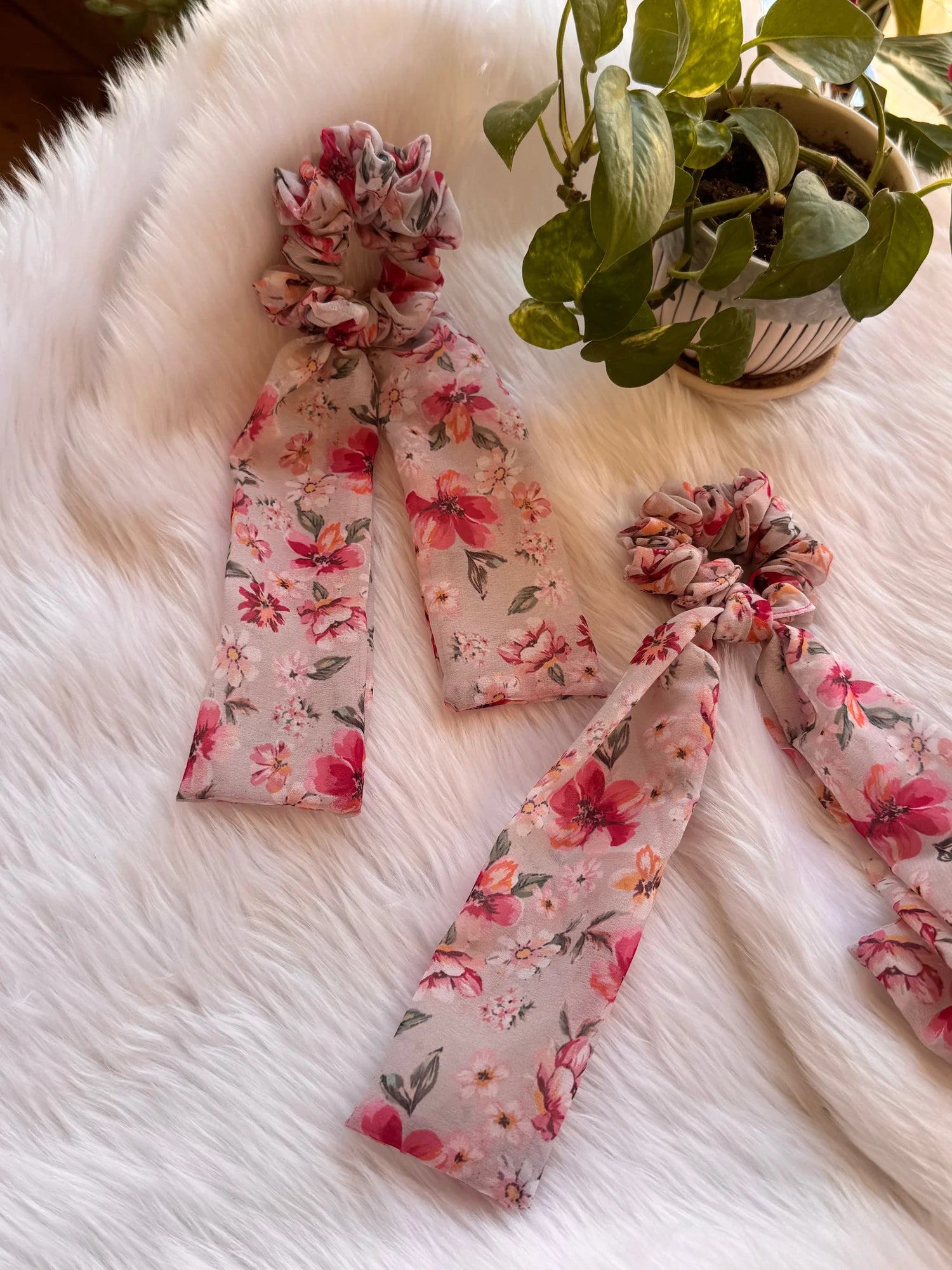 Floral pink georgette tail scrunchies with ruched fabric detail on white fur by Bows and Bags India