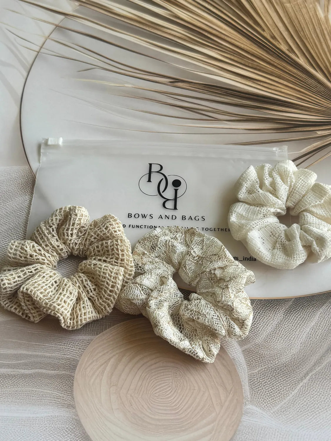 Dune Trio handmade net mesh scrunchies in cream and beige tones displayed flat with Bows and Bags India packaging and dried