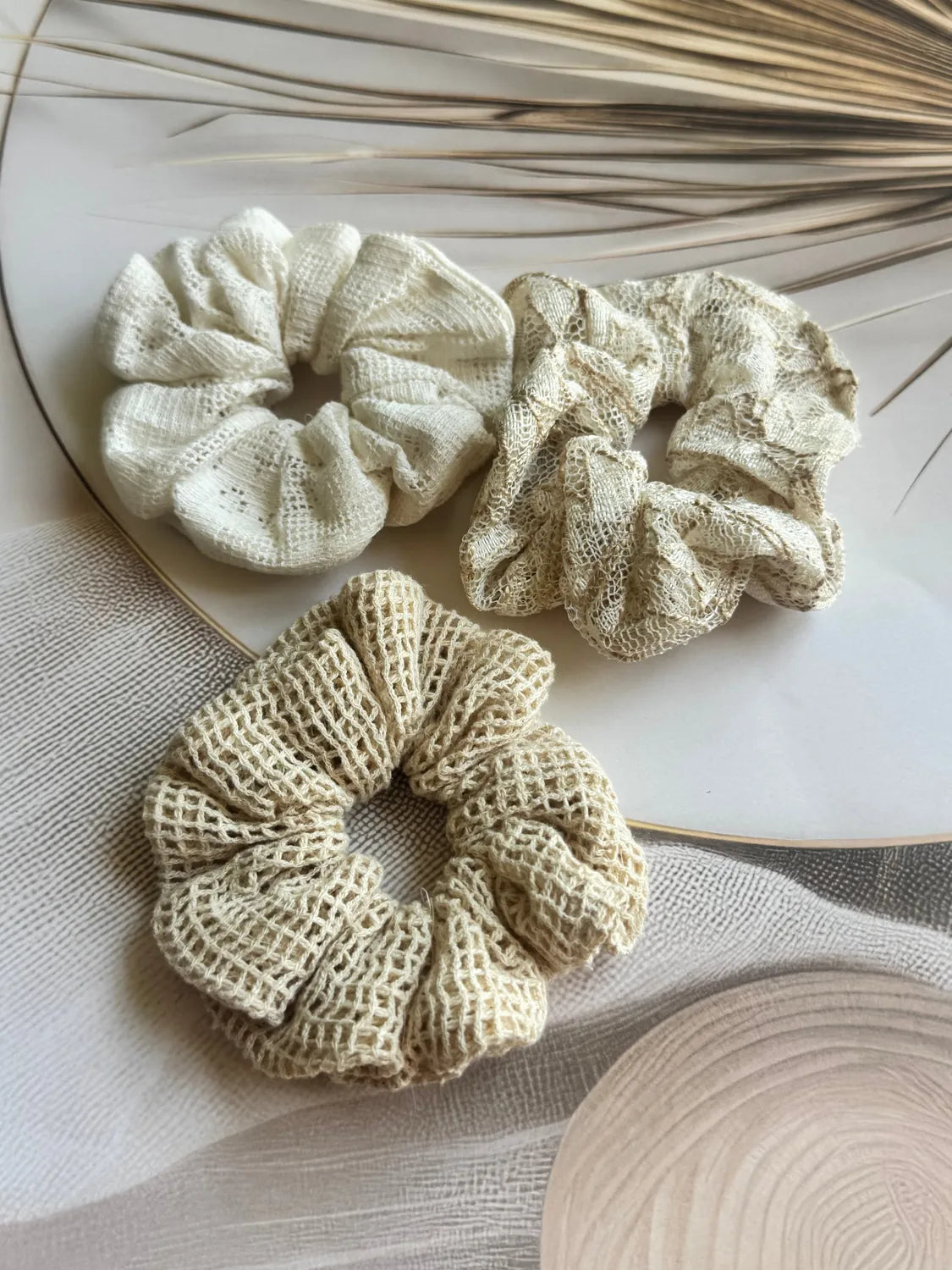 Dune Trio net mesh scrunchies in cream and beige tones displayed flat lay with dried pampas grass by Bows and Bags India