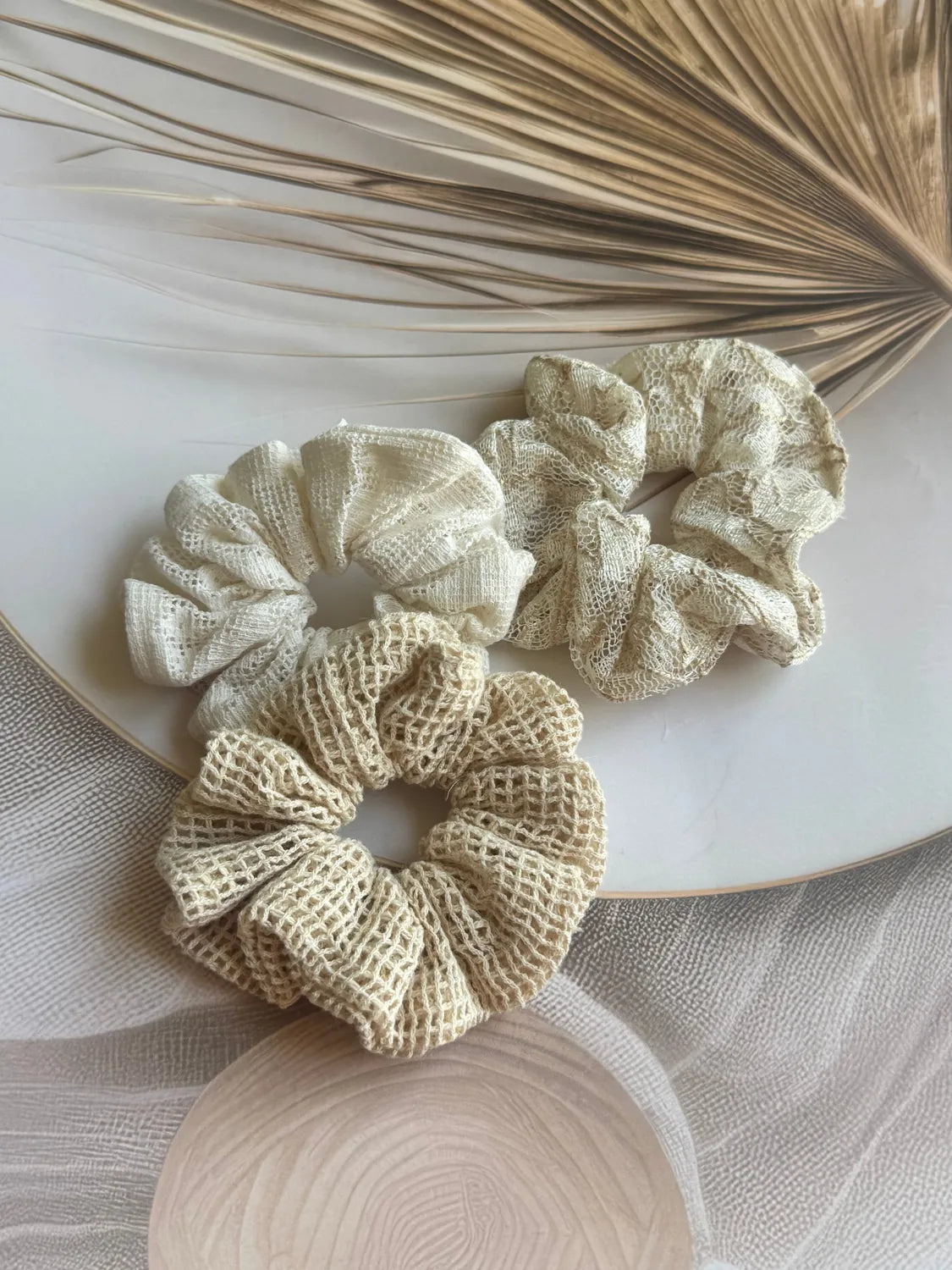 Three handmade net mesh scrunchies in cream and beige tones from Bows and Bags India Dune Trio set, styled flat lay with