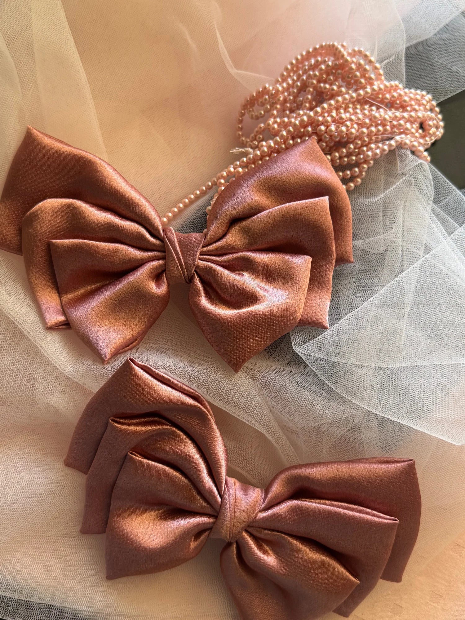 Metallic peach satin hair bow with pearl beaded accessory detail by Bows and Bags India, handmade bow styling