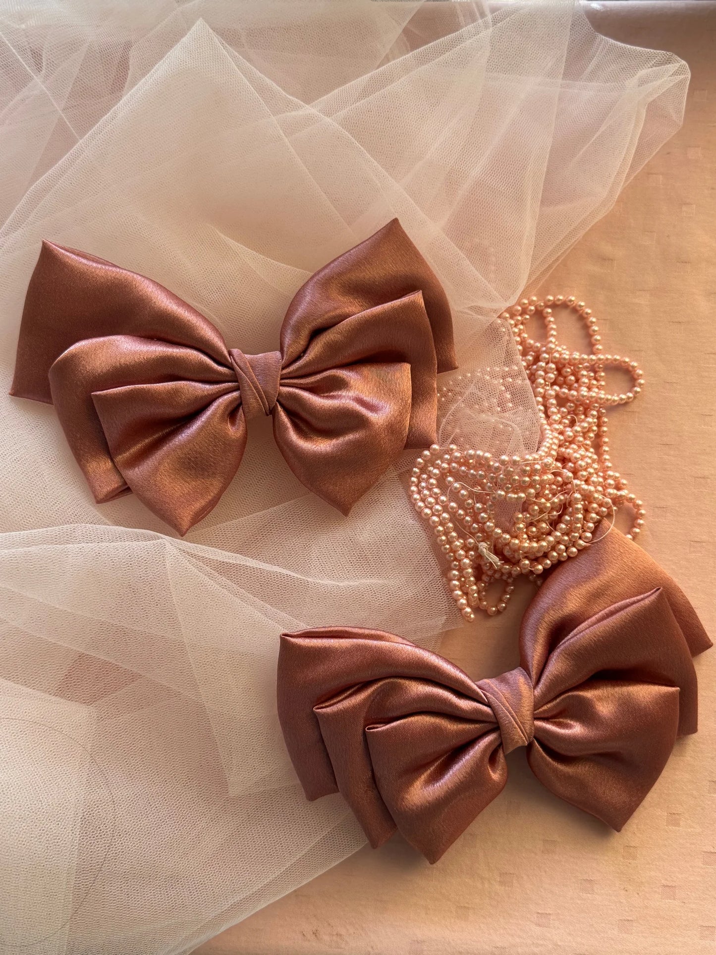 Metallic peach satin hair bow with pearl beads and tulle styling by Bows and Bags India handmade accessories