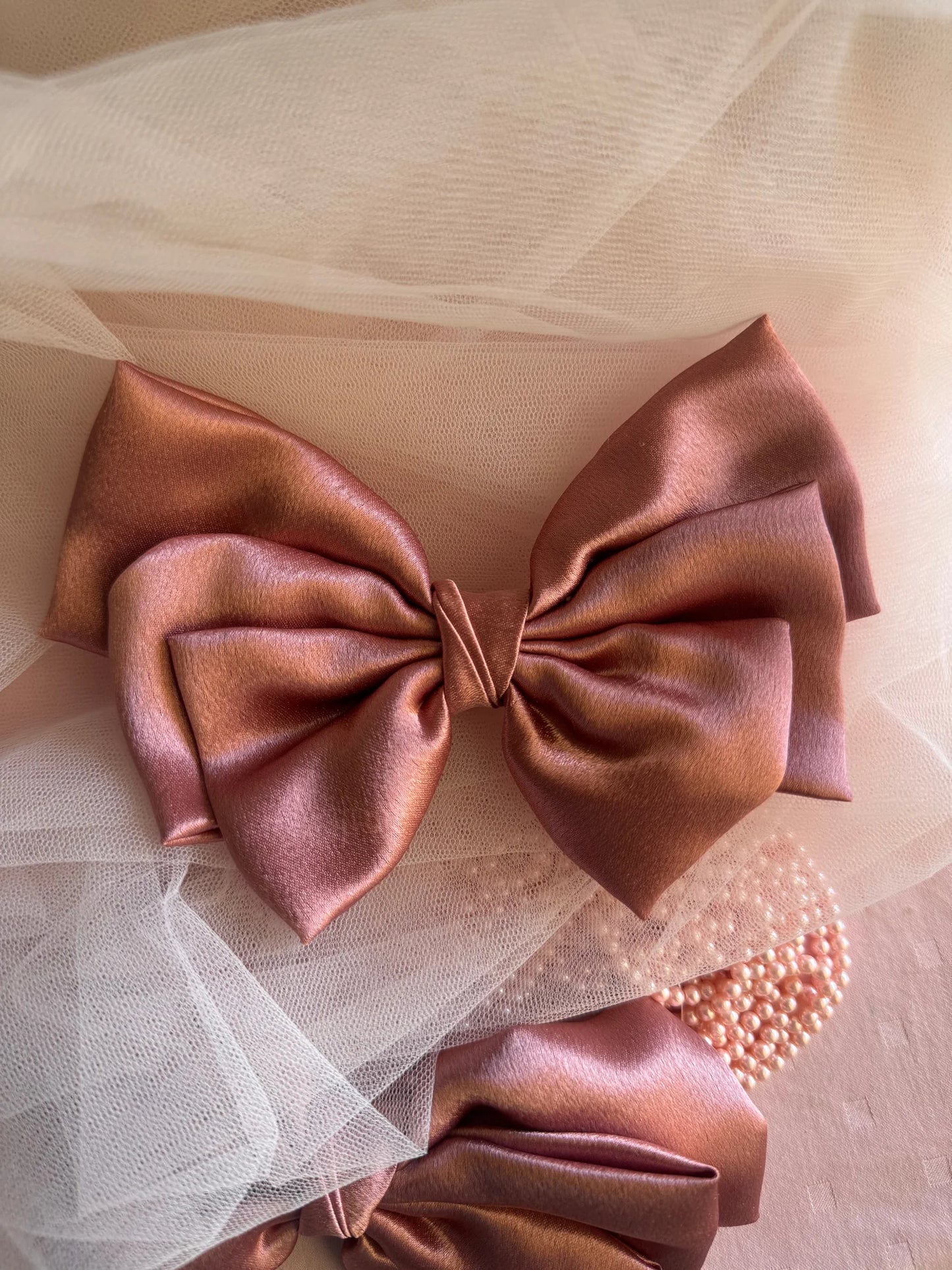 Metallic peach satin hair bow by Bows and Bags India with pearl beaded detail and sheer tulle, handmade accessory styling