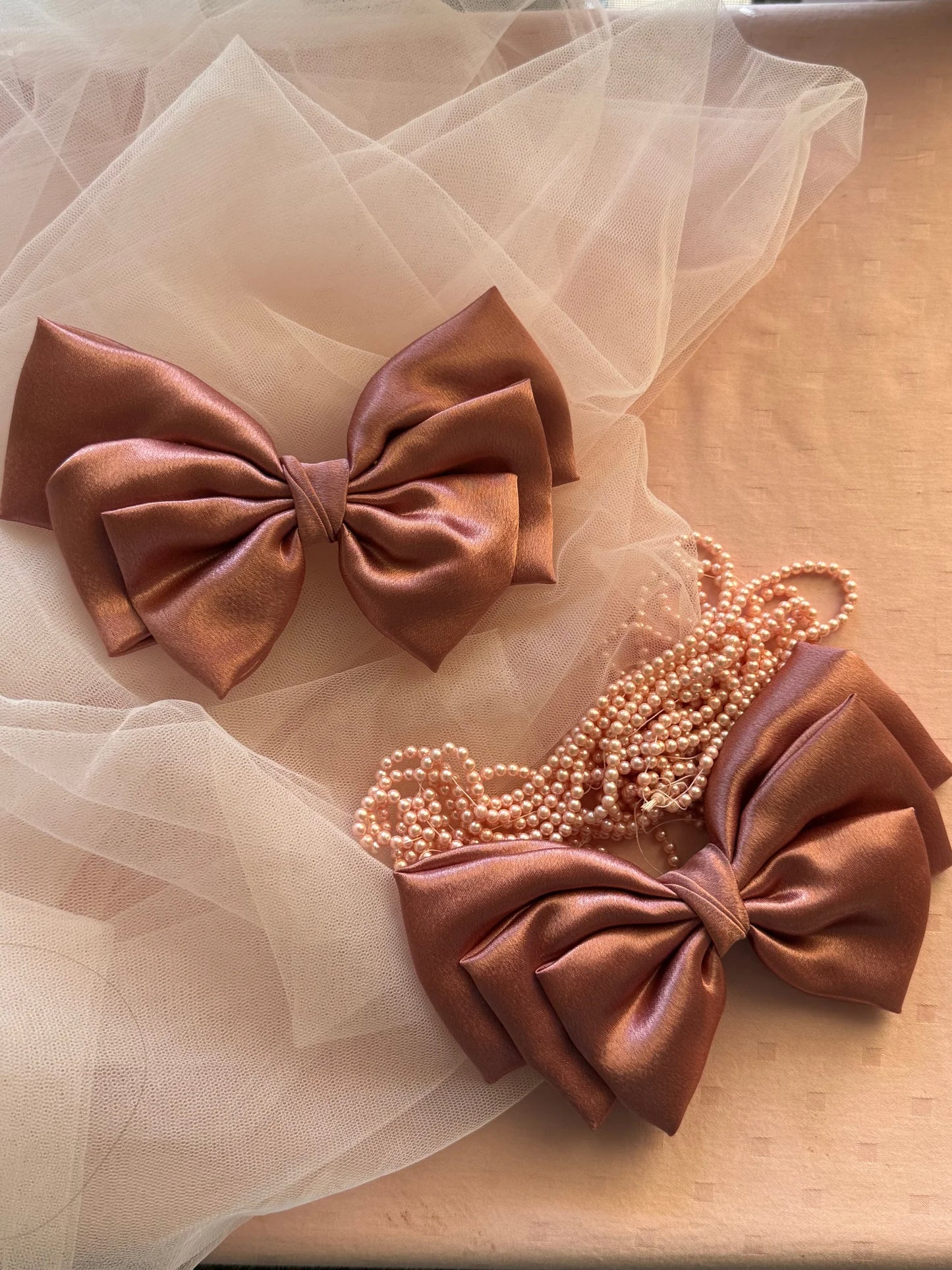 Metallic peach satin hair bow with pearl beaded necklace on tulle fabric, handmade accessory by Bows and Bags India