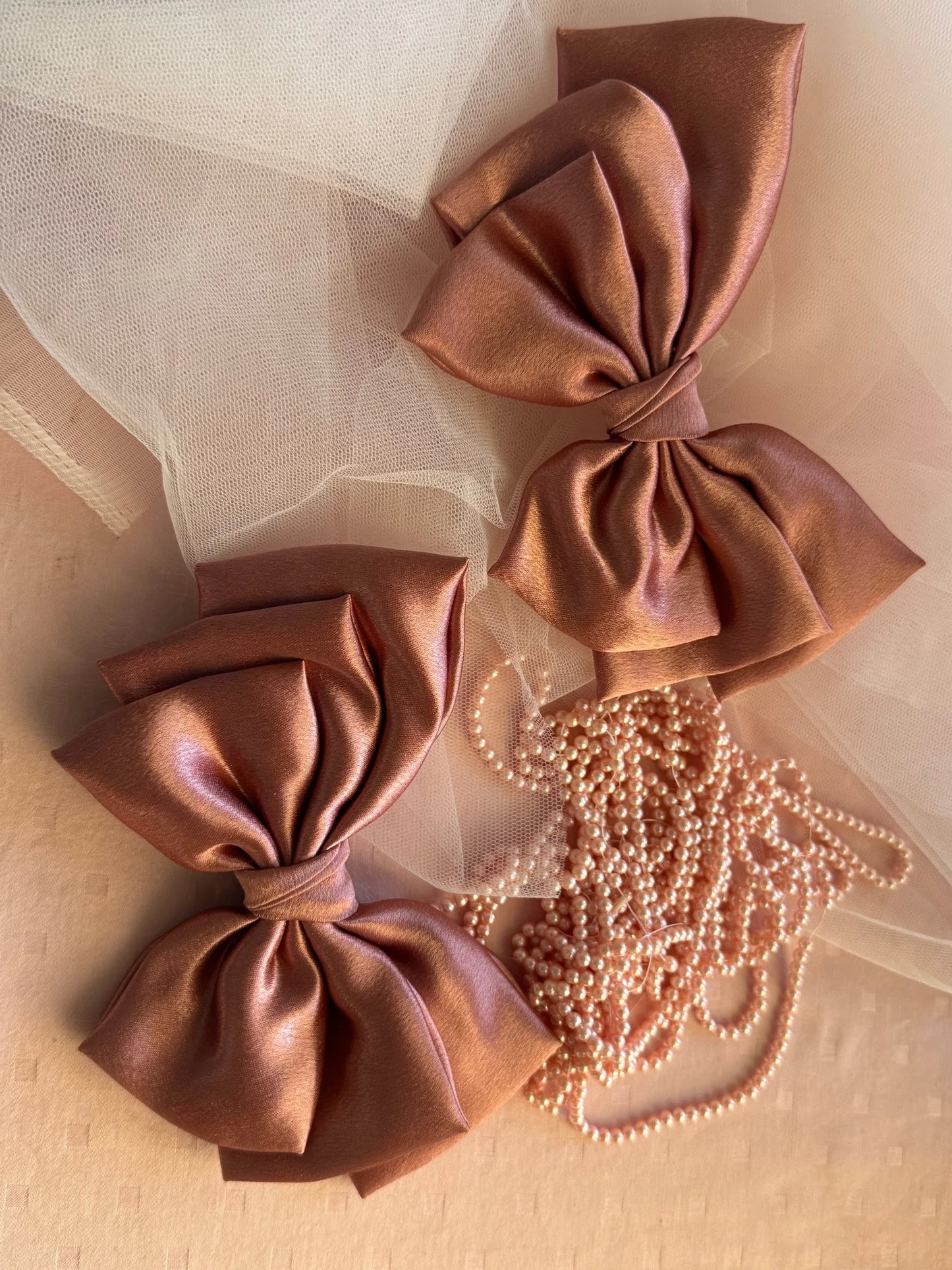 Metallic peach satin hair bows with pearl beaded accessories by Bows and Bags India, handmade luxury hair accessory detail