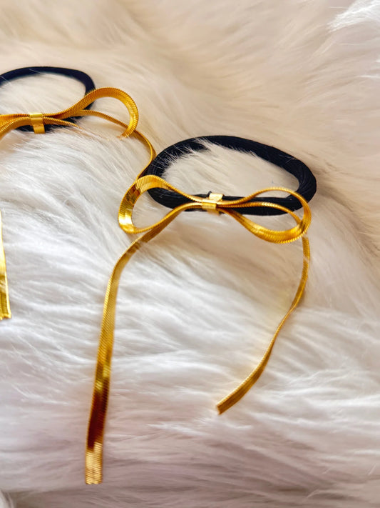 Golden chain bow metal rubber bands in gold and black on white fur, Bows and Bags India handmade hair accessories