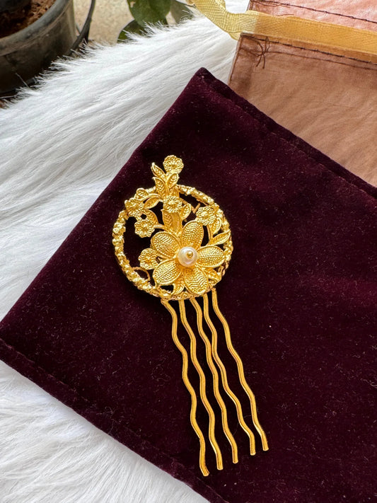 Golden Flora hair pin with intricate textured flowers and pearl center on burgundy velvet by Bows and Bags India