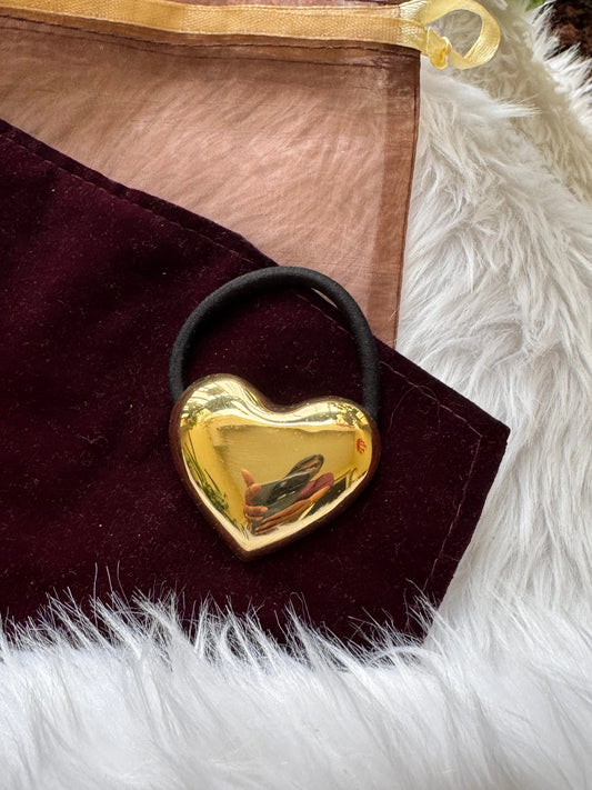 Golden heart metal hair rubber band by Bows and Bags India on burgundy velvet with gold trim and white fur styling