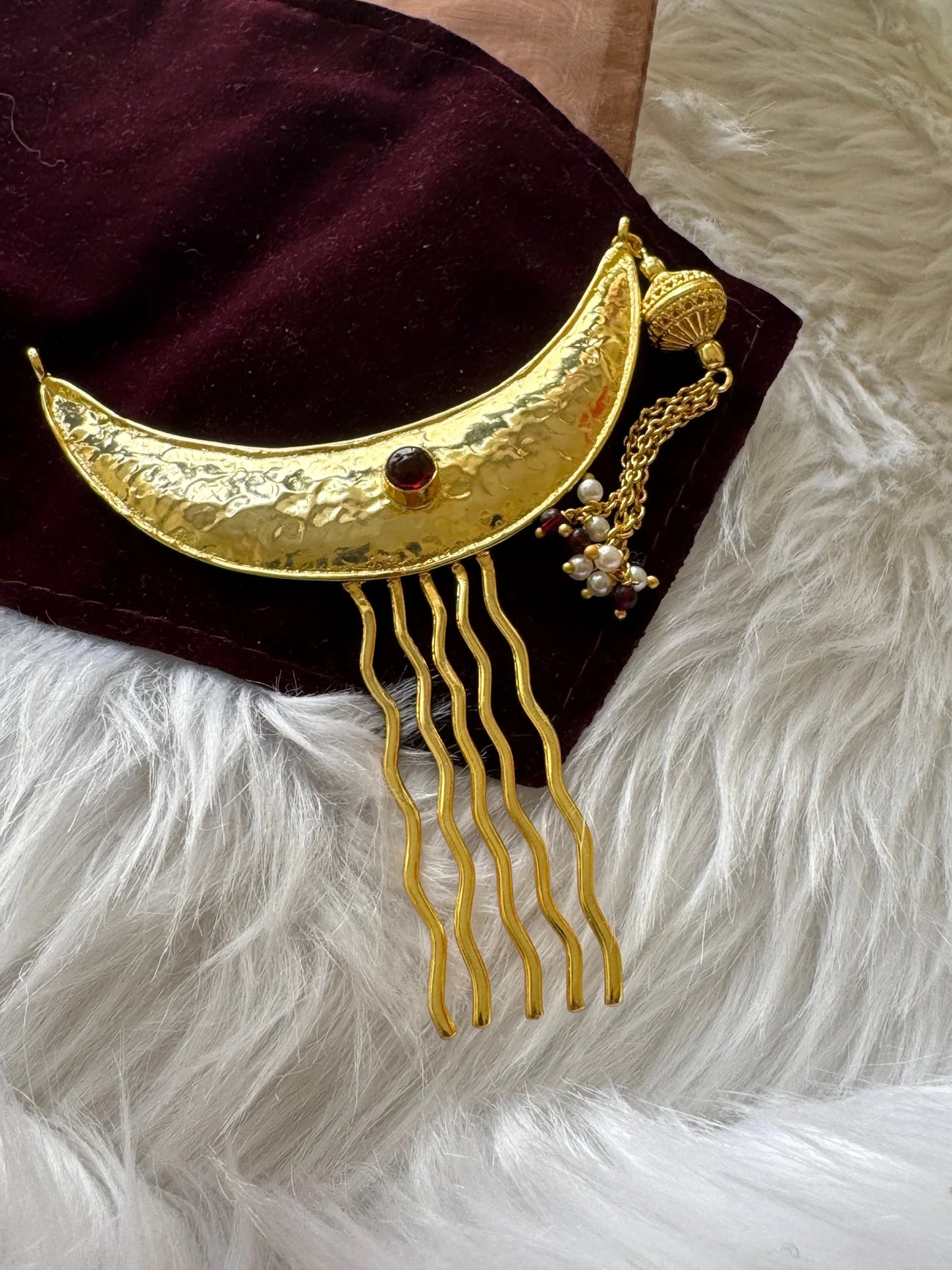 Golden Moon hair pin with hammered gold crescent, red stone, and dangling pearl charms by Bows and Bags India on velvet